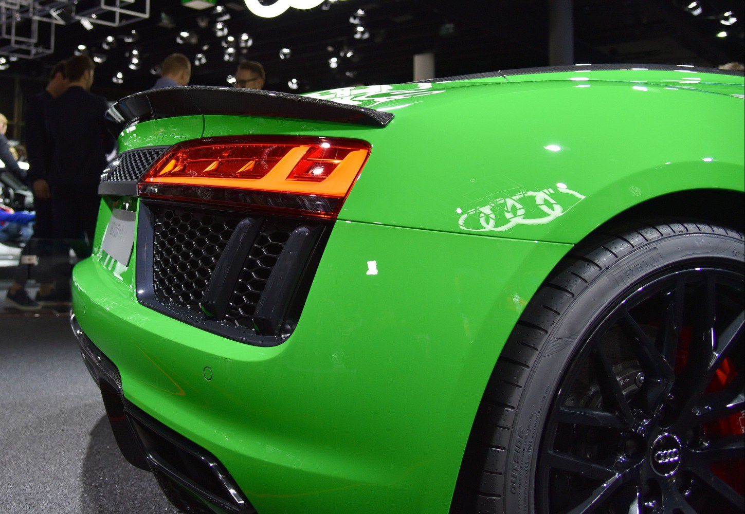 Rear taillight and wheel of a vibrant green sports car