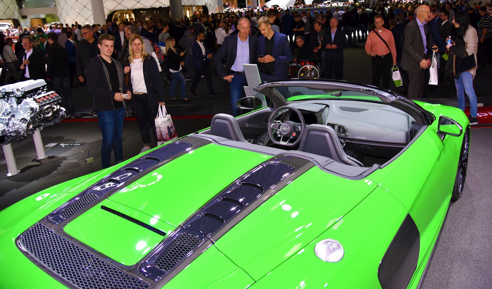 Vibrant green convertible with carbon fiber details and open cockpit interior
