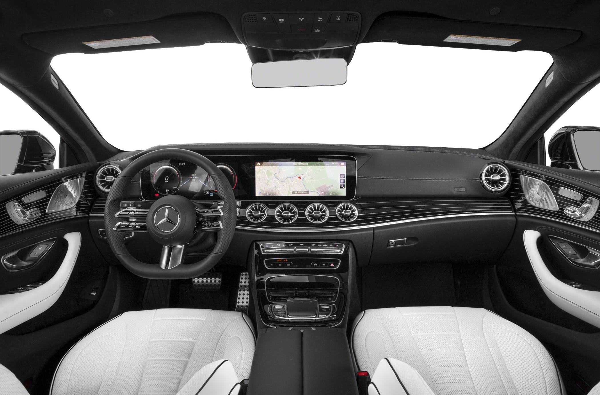 Luxury dashboard and digital infotainment system with white leather seats.
