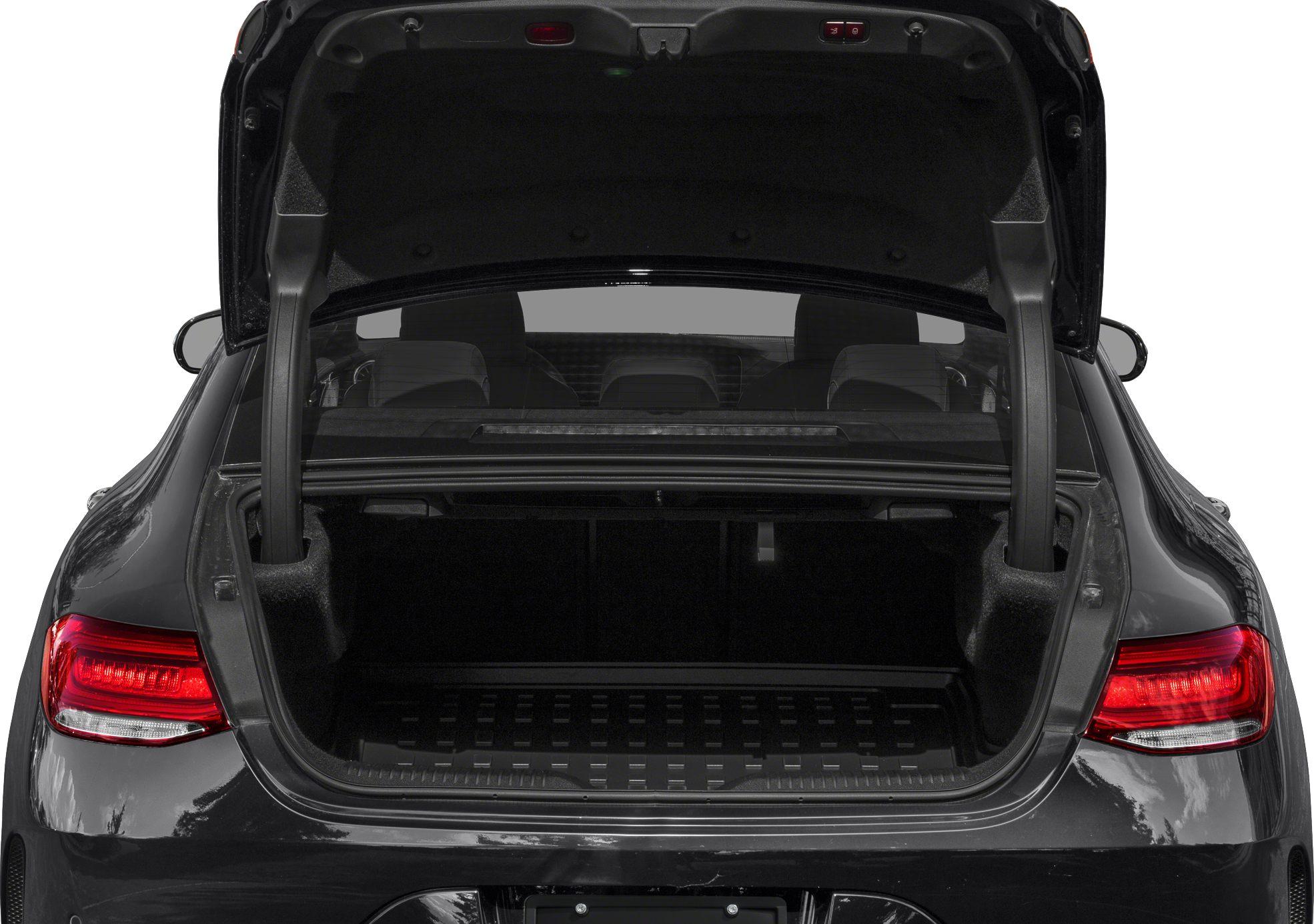 Rear view of open trunk with visible interior space and rear seats.