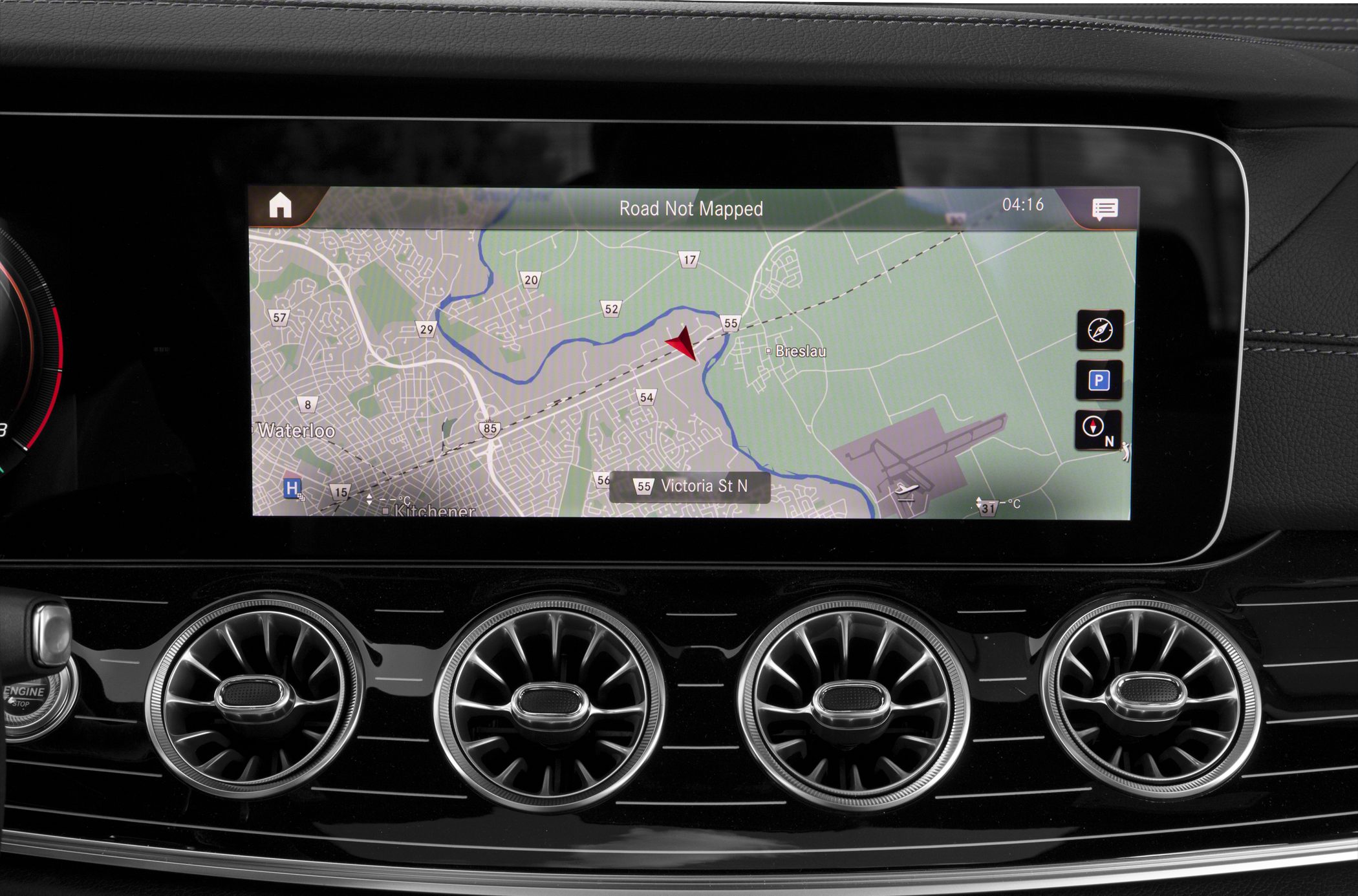 Digital infotainment screen with round air vents in car dashboard