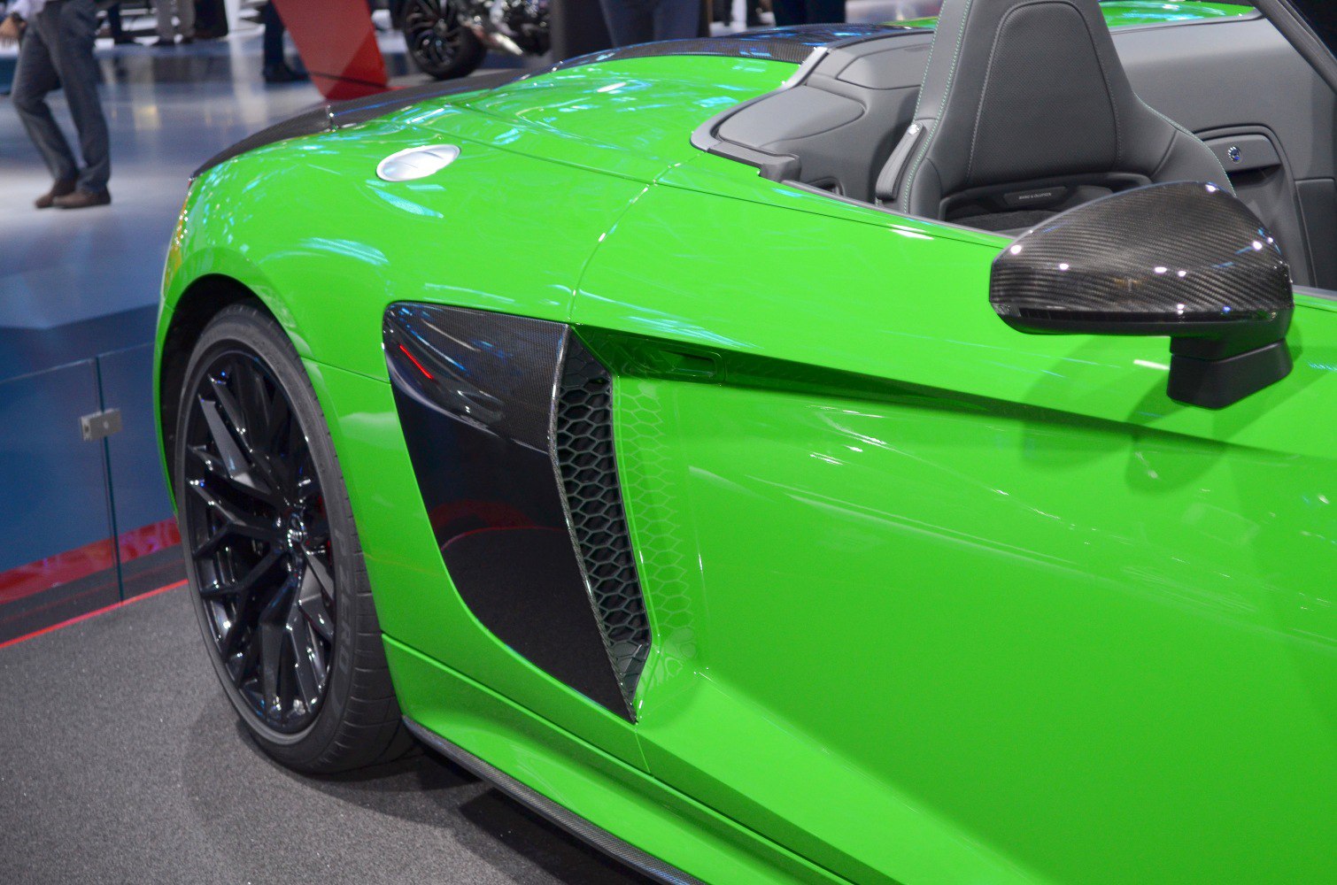 Green car side with carbon fiber mirror and air intake vent