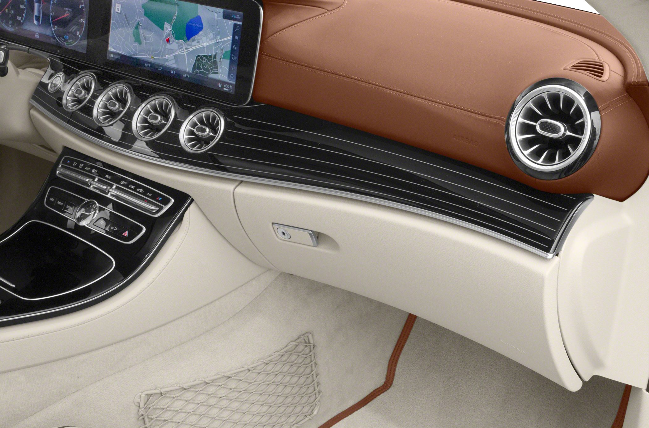 Dashboard with navigation display and multiple circular air vents.