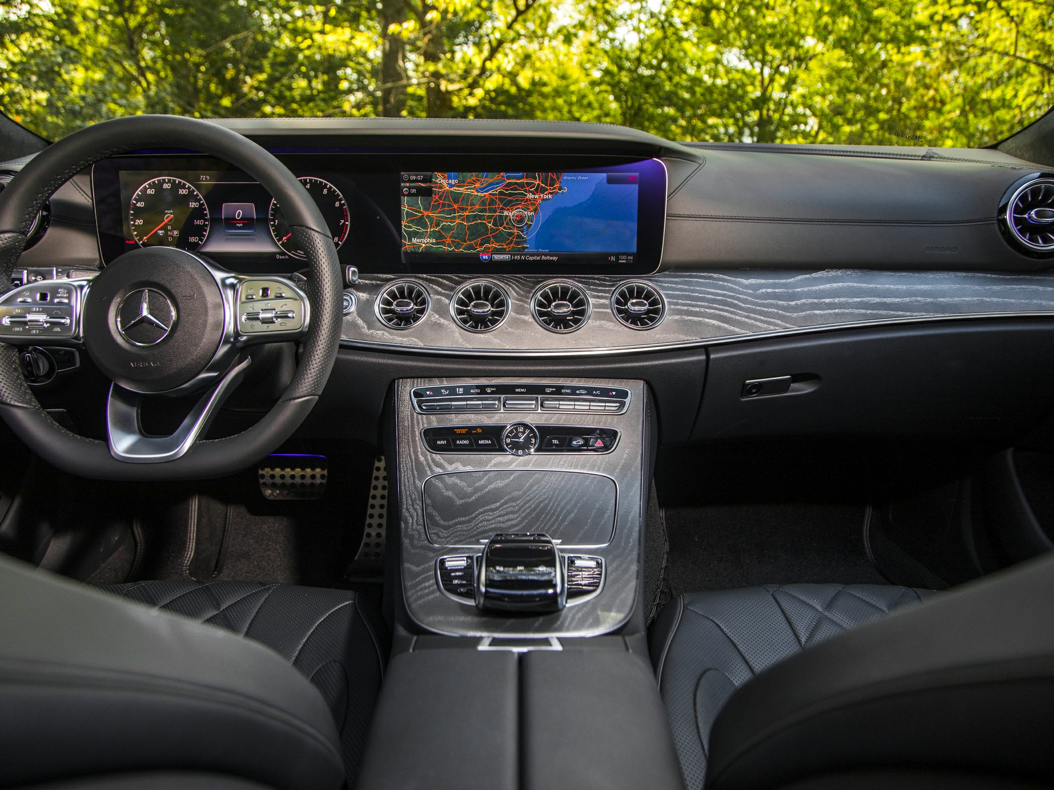 Digital dashboard and navigation display with circular air vents.
