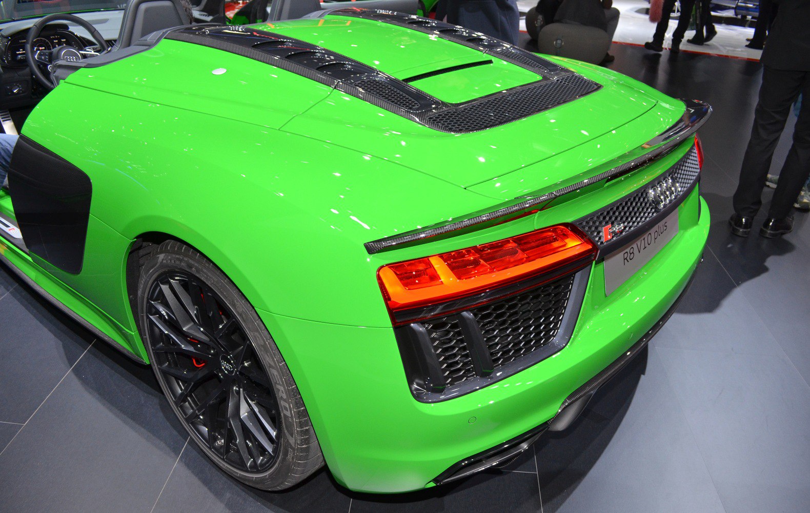 Close-up of rear design, tail lights, rear vents, and sporty black wheel.