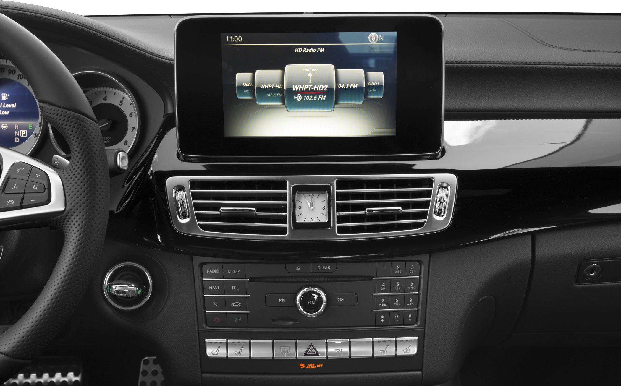 Infotainment screen and analog clock on luxury car center console