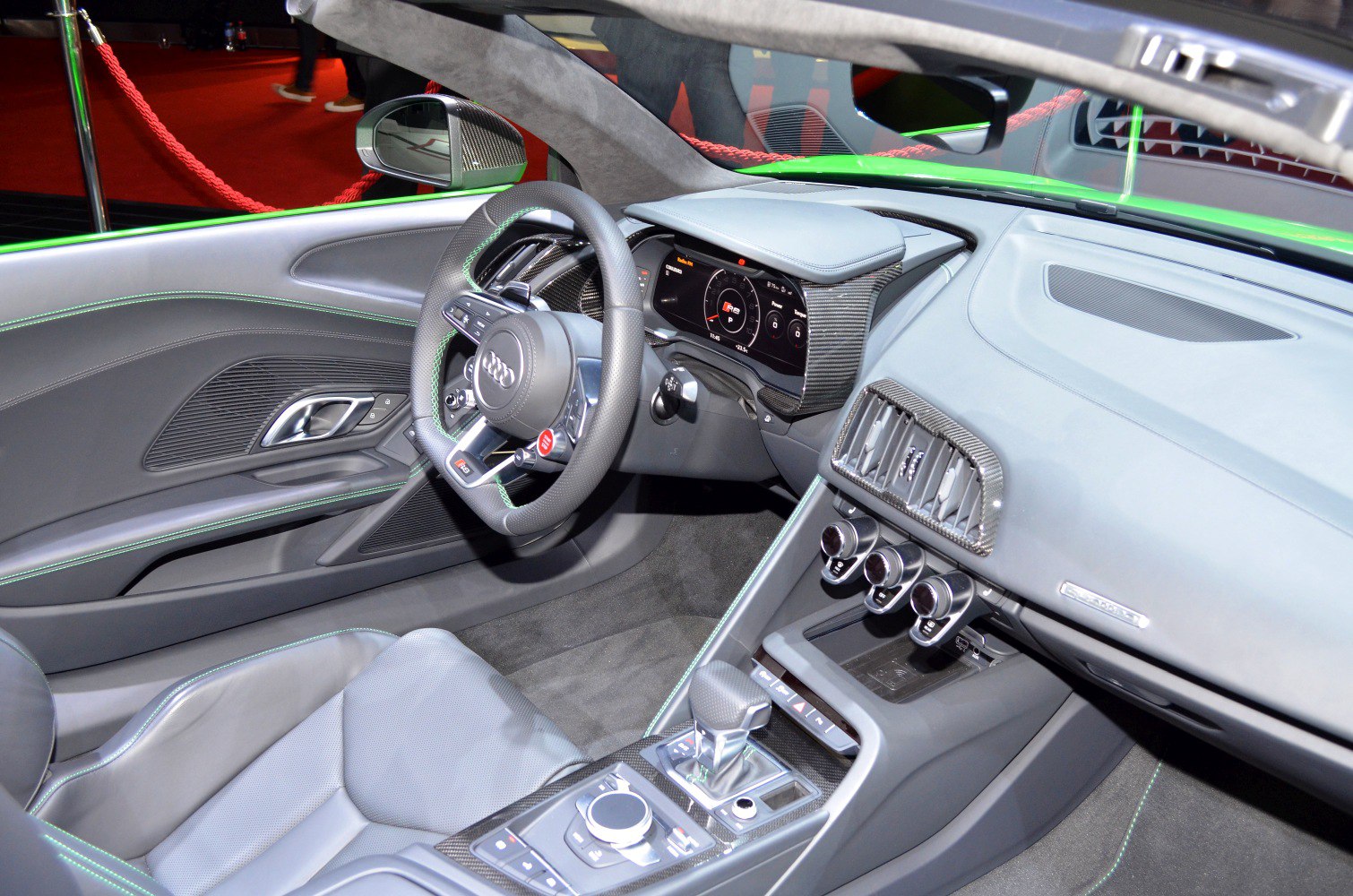Sporty steering wheel and modern digital dashboard with carbon fiber accents