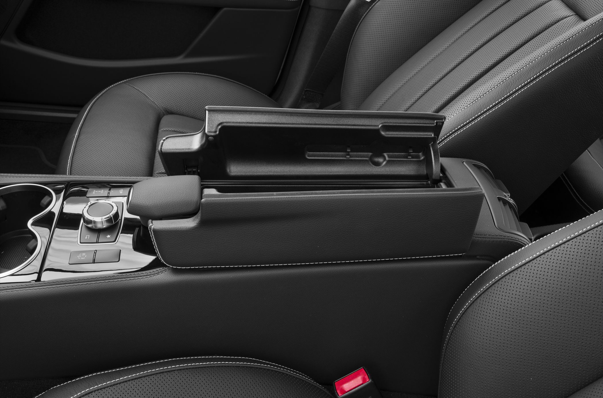 Center console with storage, control knob, and cup holders in leather interior