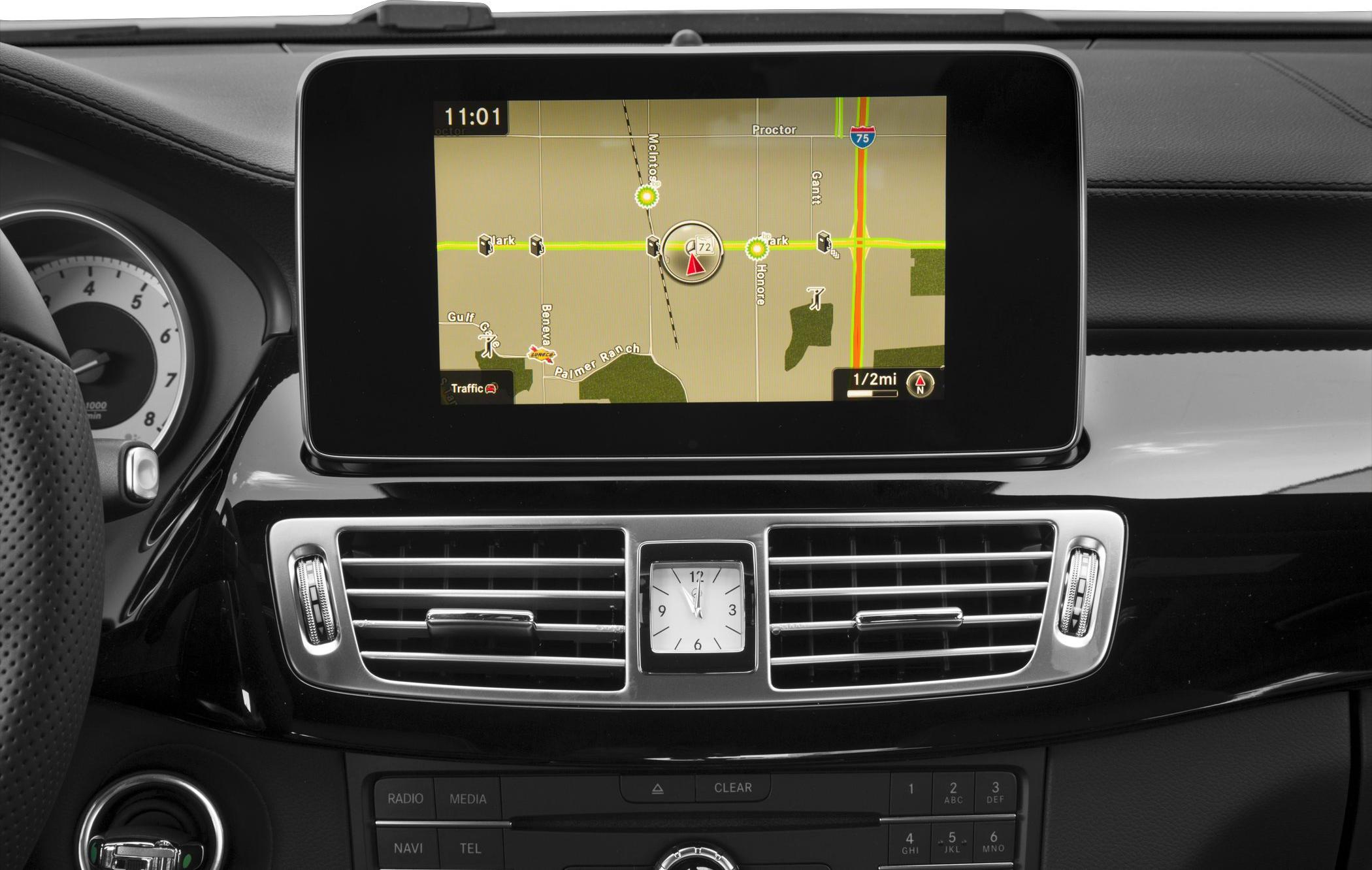 Infotainment screen with navigation, analog clock, and air vents