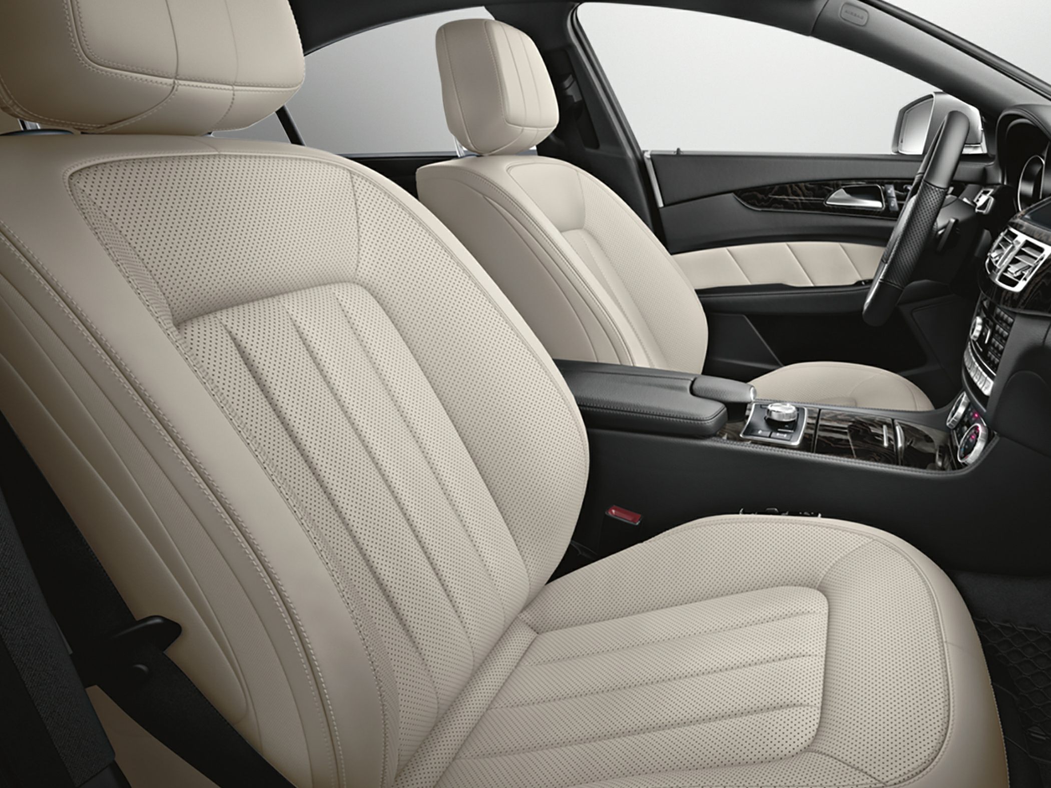 Beige perforated leather seats with wood finish dashboard and modern controls