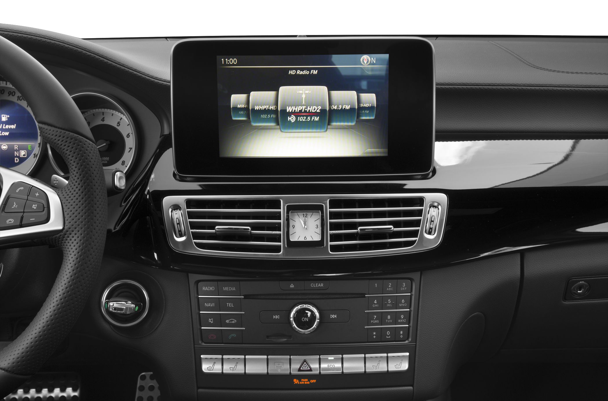 Central touchscreen, analog clock, dashboard controls, steering wheel section
