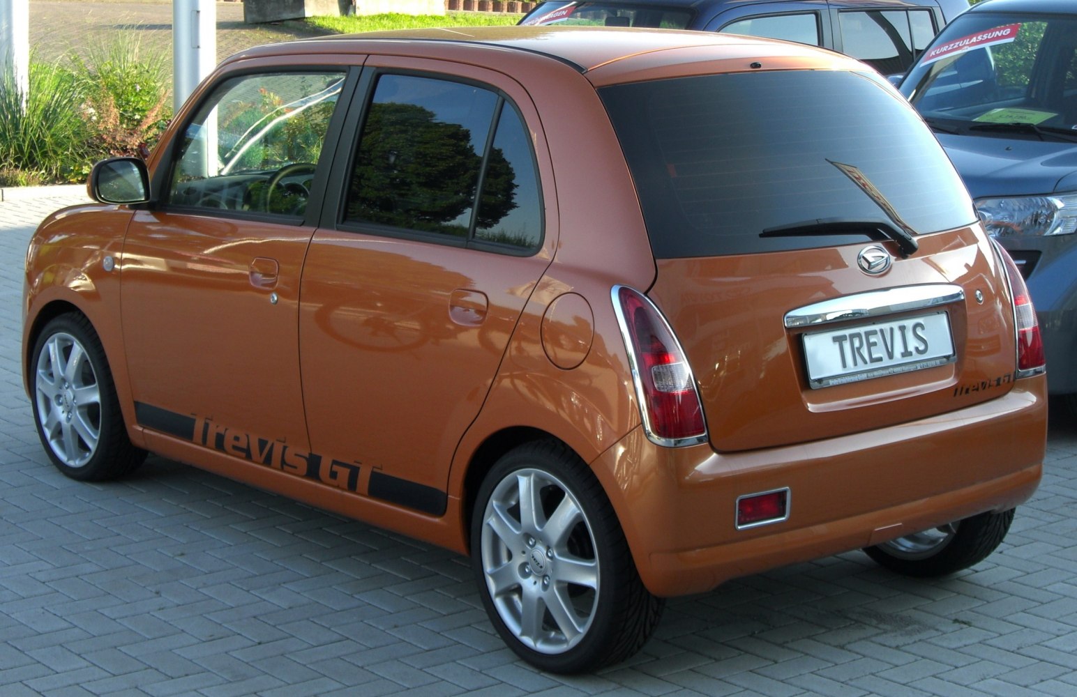 Rear and side view of a compact hatchback with GT decal and alloy wheels
