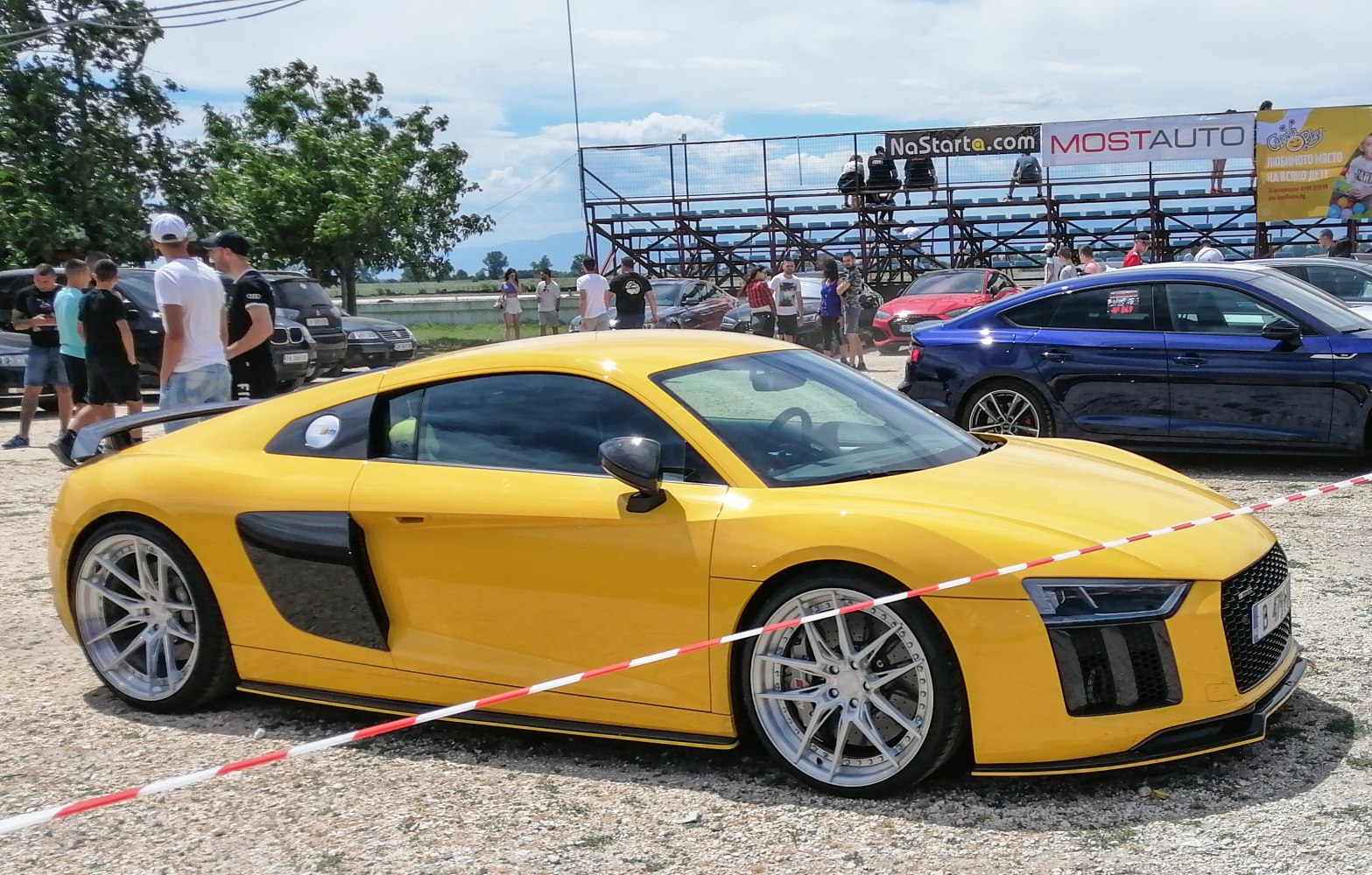 Yellow sports coupe with aerodynamic side air intakes and large alloy wheels