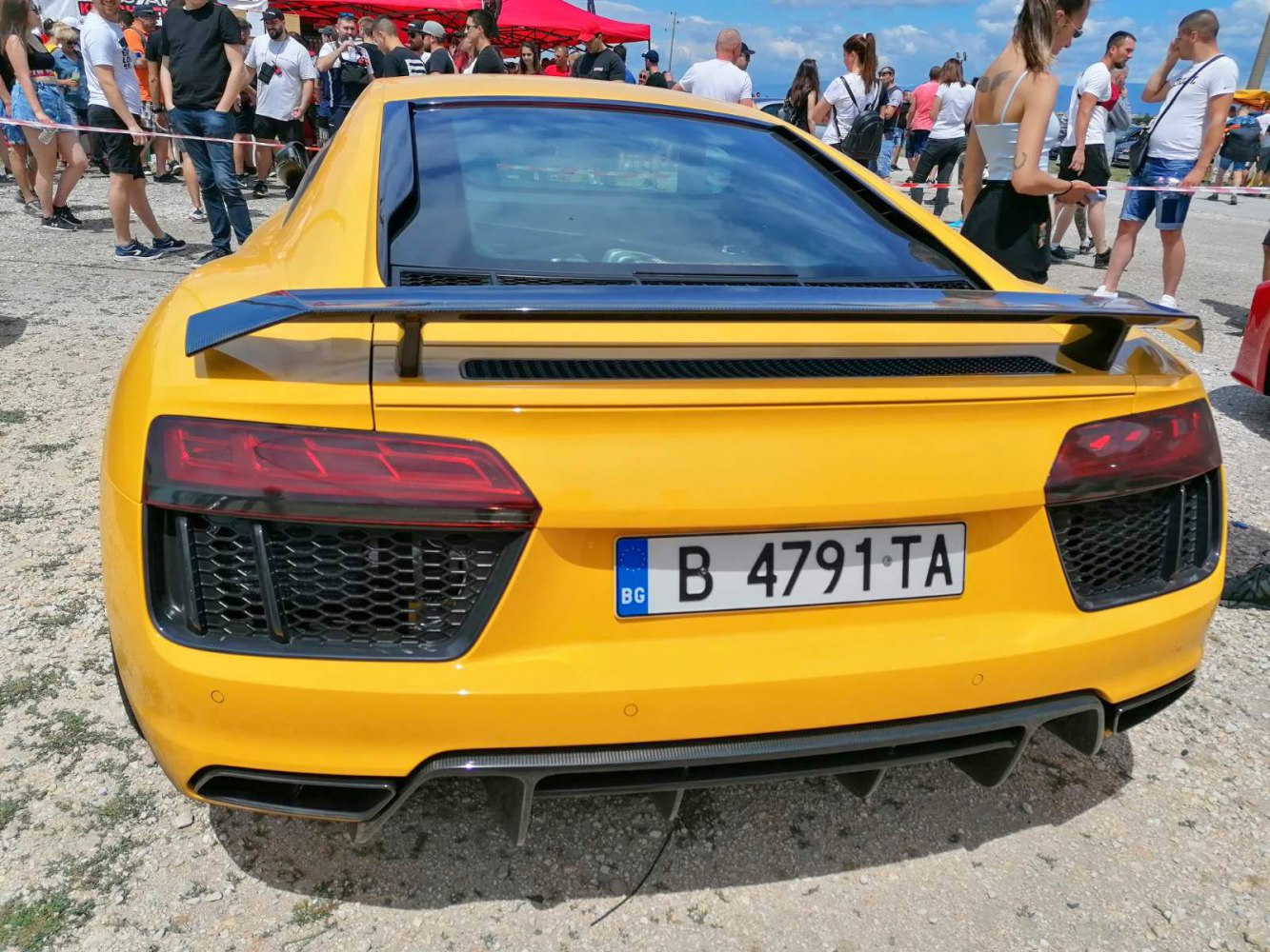 Yellow rear with prominent spoiler and tail lights