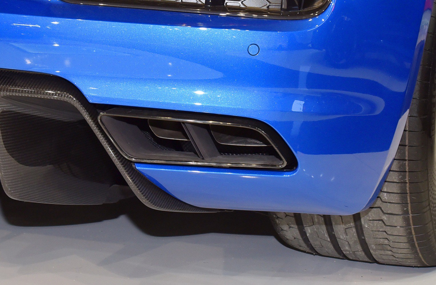 Rear exhaust and carbon fiber diffuser detail on a sports car