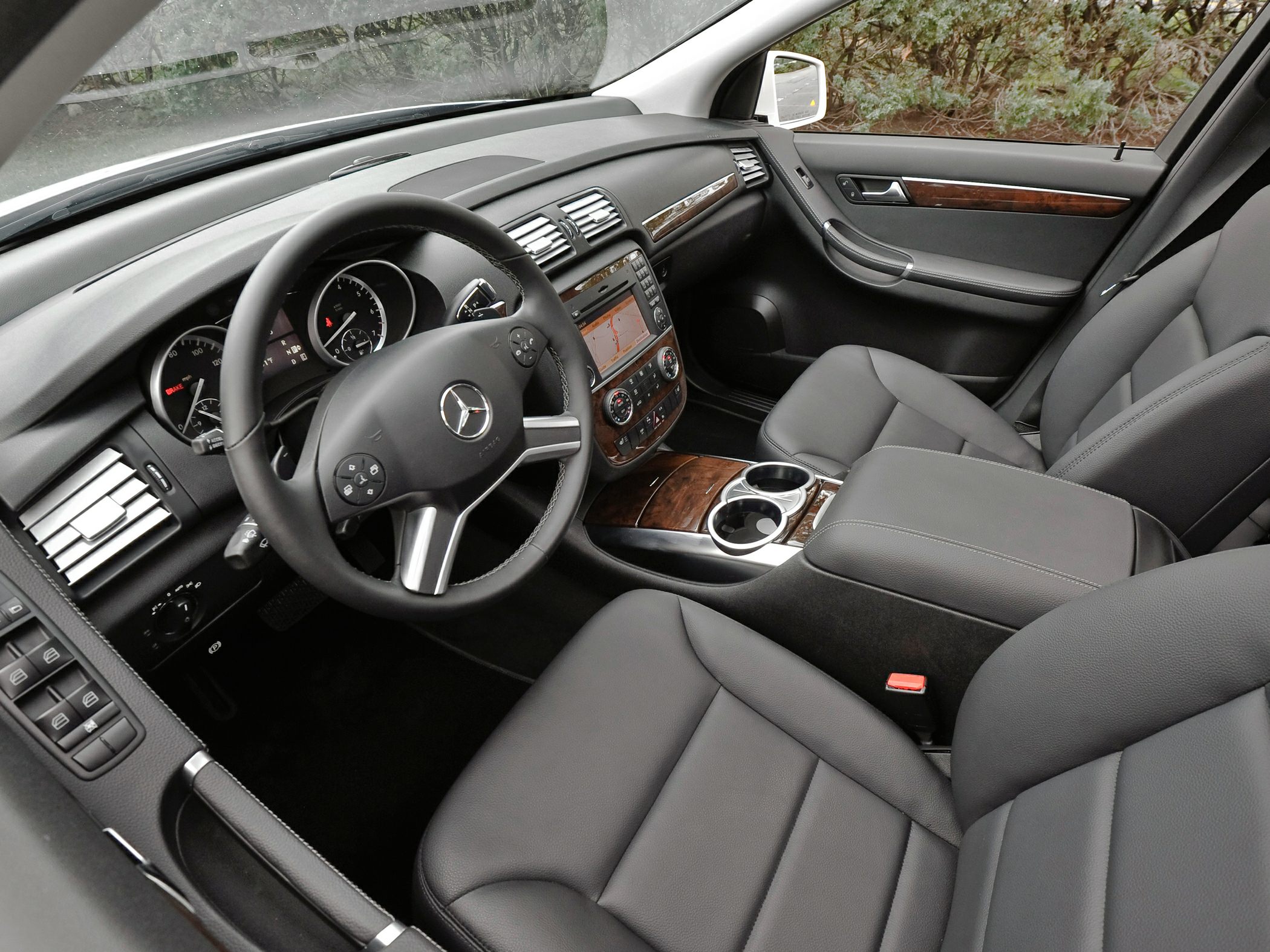 Luxury interior with leather seats, wood trim, and integrated navigation system