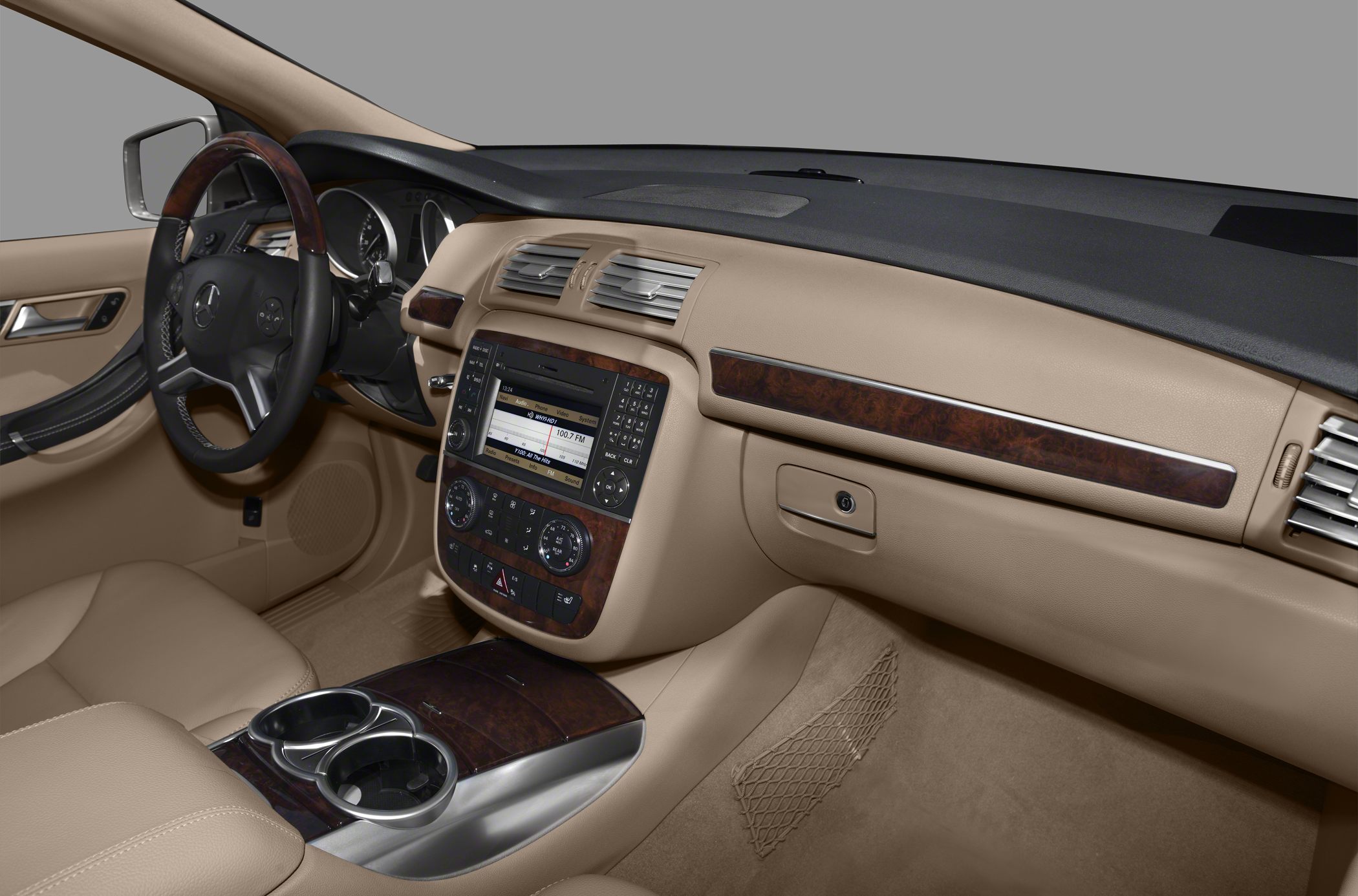Beige interior dashboard with wooden trim and media console.