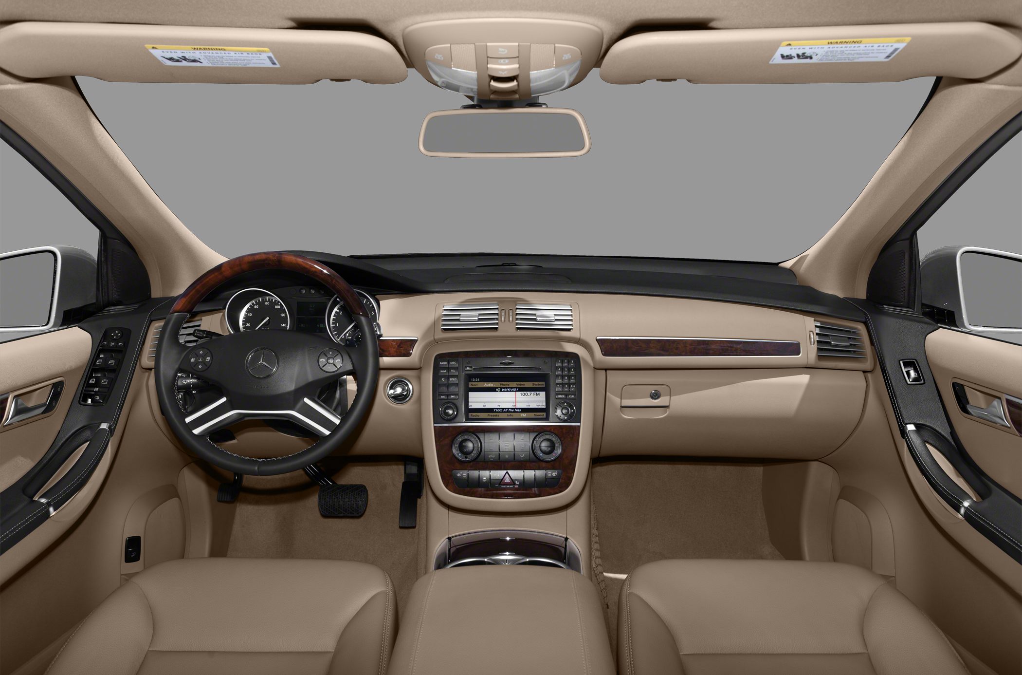 Luxury beige interior with wood-trimmed dashboard and advanced controls