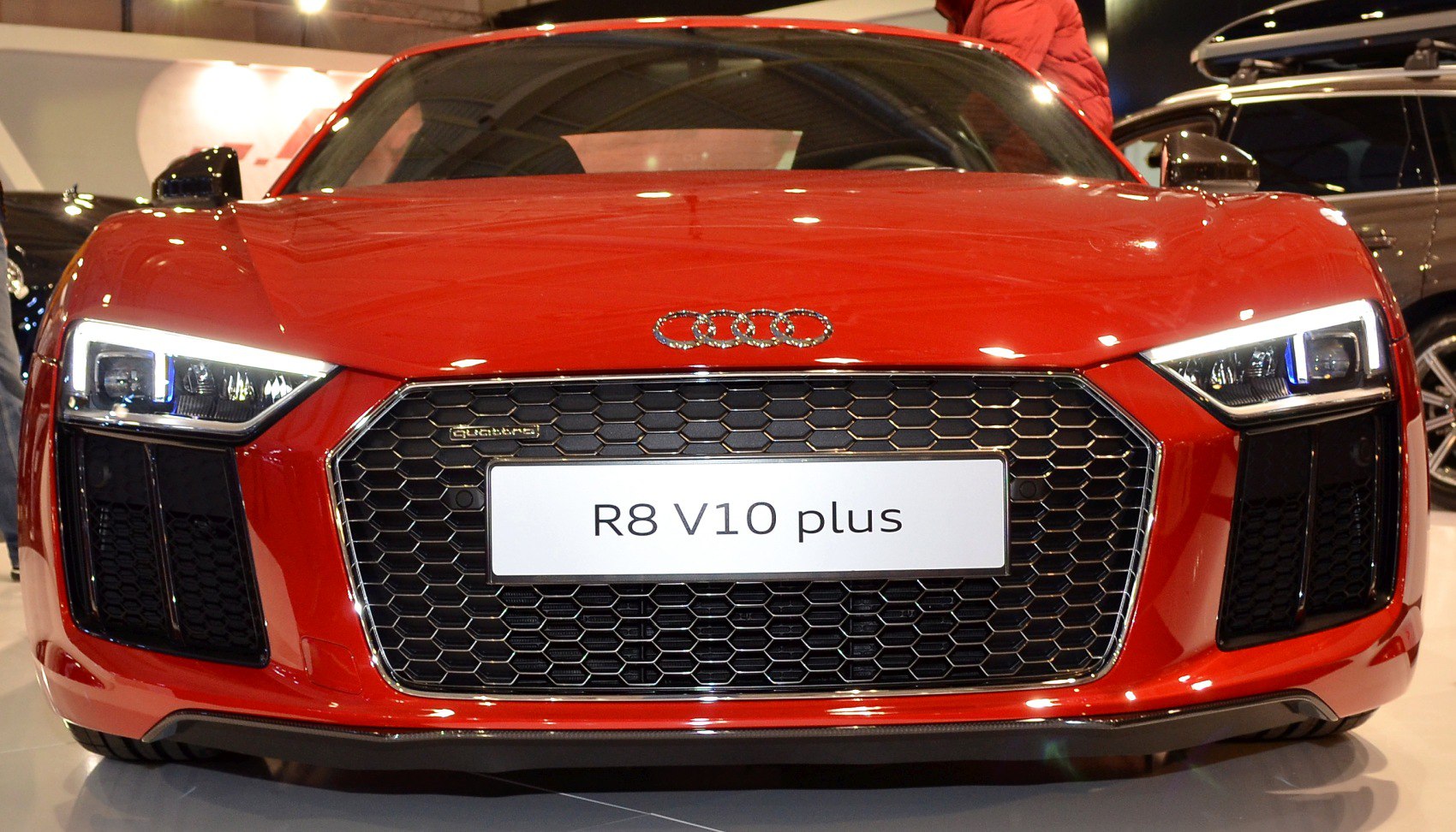 Front grille and LED headlights of a red sports coupe