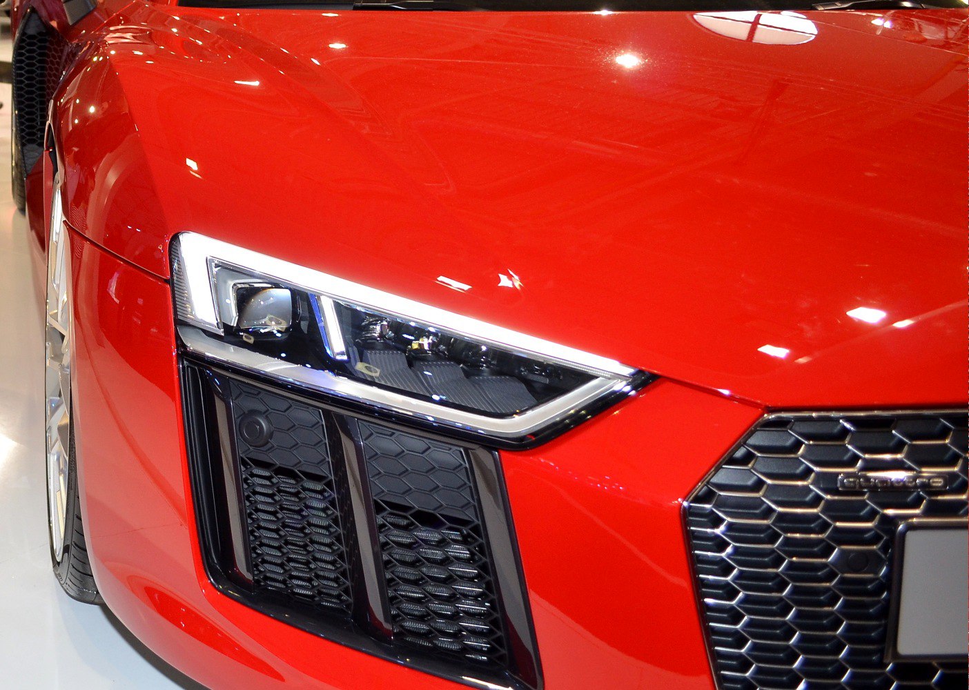 Sharp LED headlight and honeycomb front grille in red car