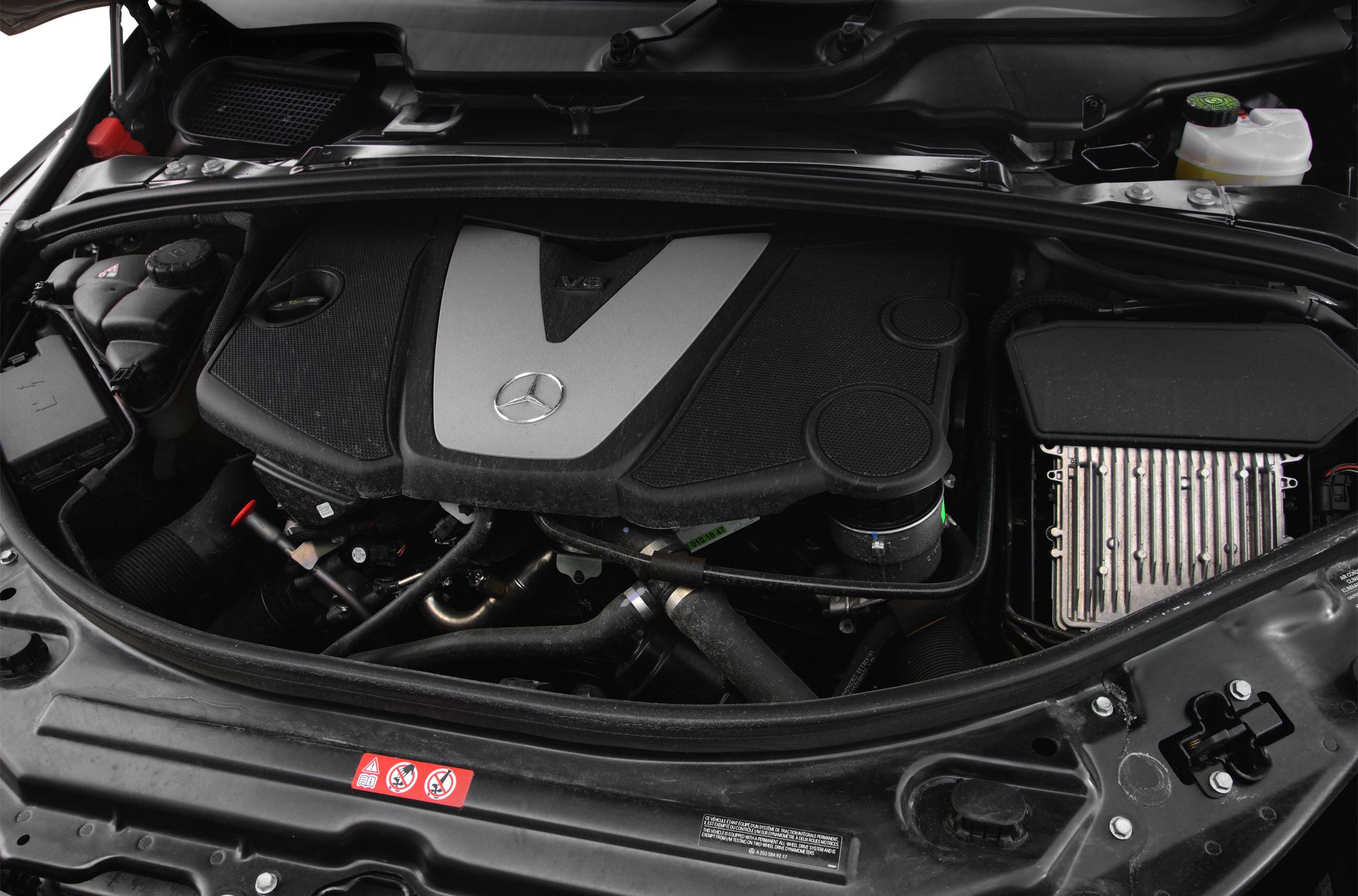 V6 engine with Mercedes-Benz emblem in engine compartment