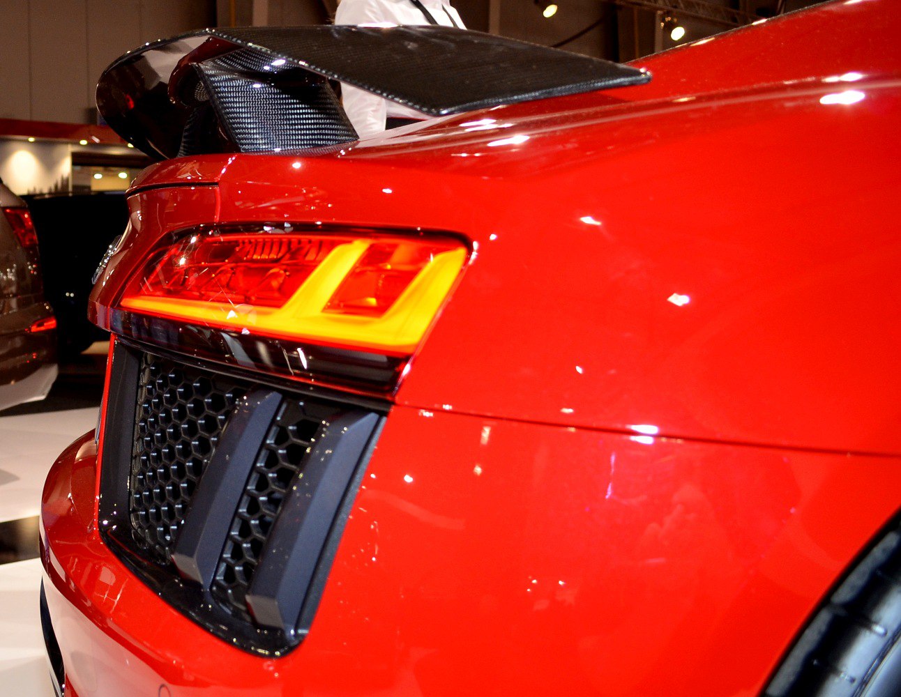 Rear LED taillights and carbon fiber spoiler on red sports car
