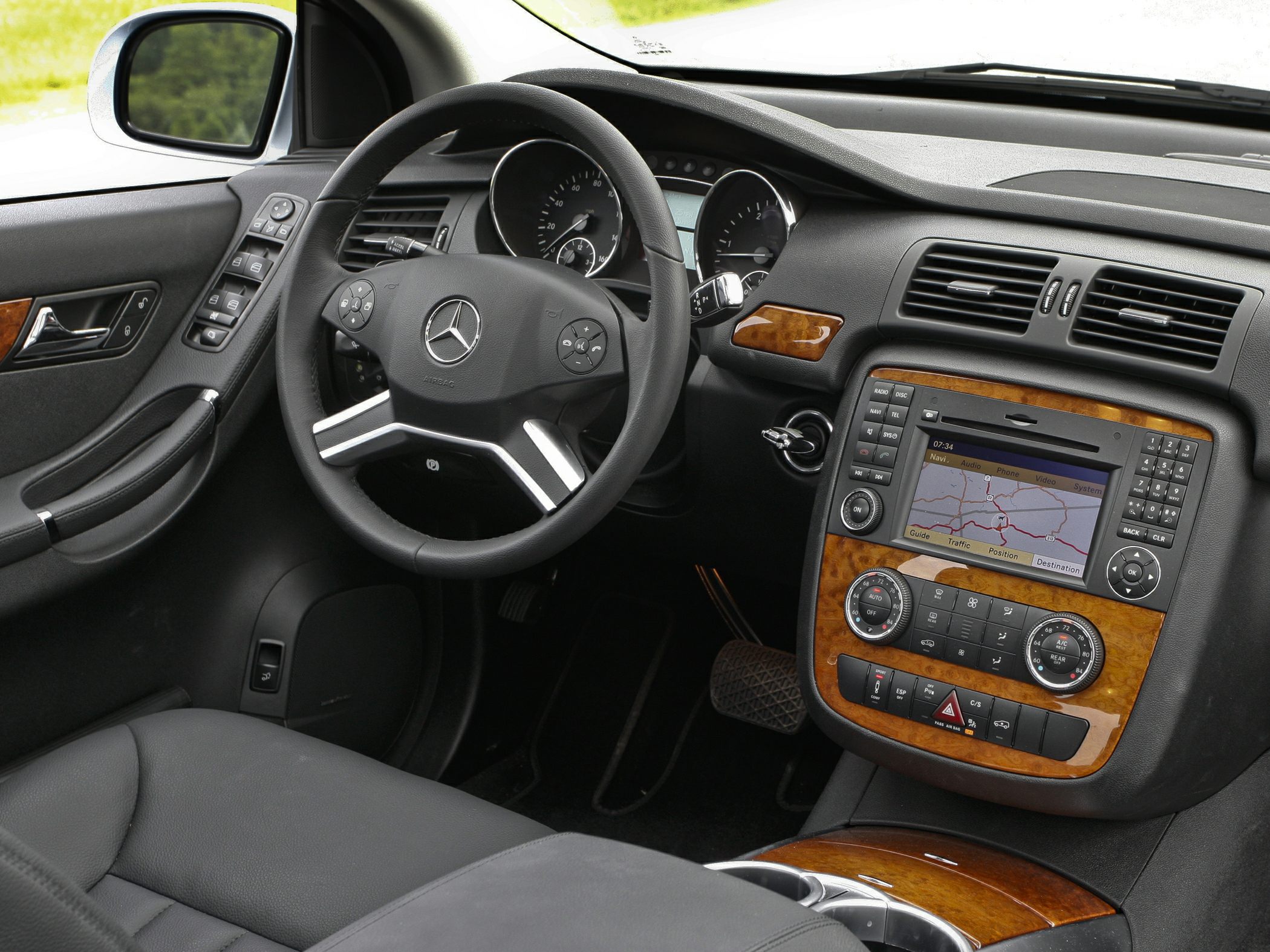 Luxury car interior with wood trim and integrated navigation system