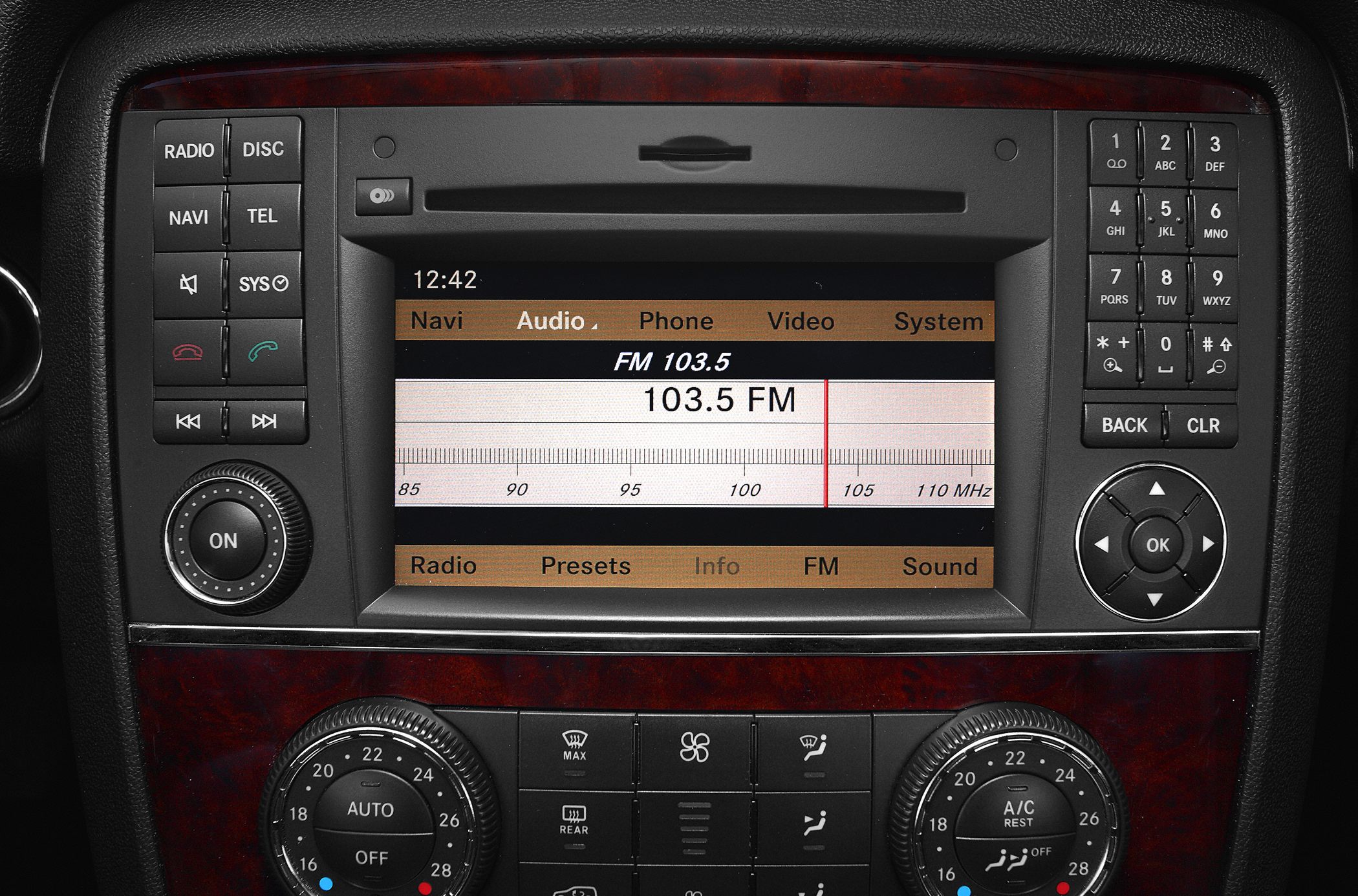 Infotainment system and climate control panel with radio and navigation buttons