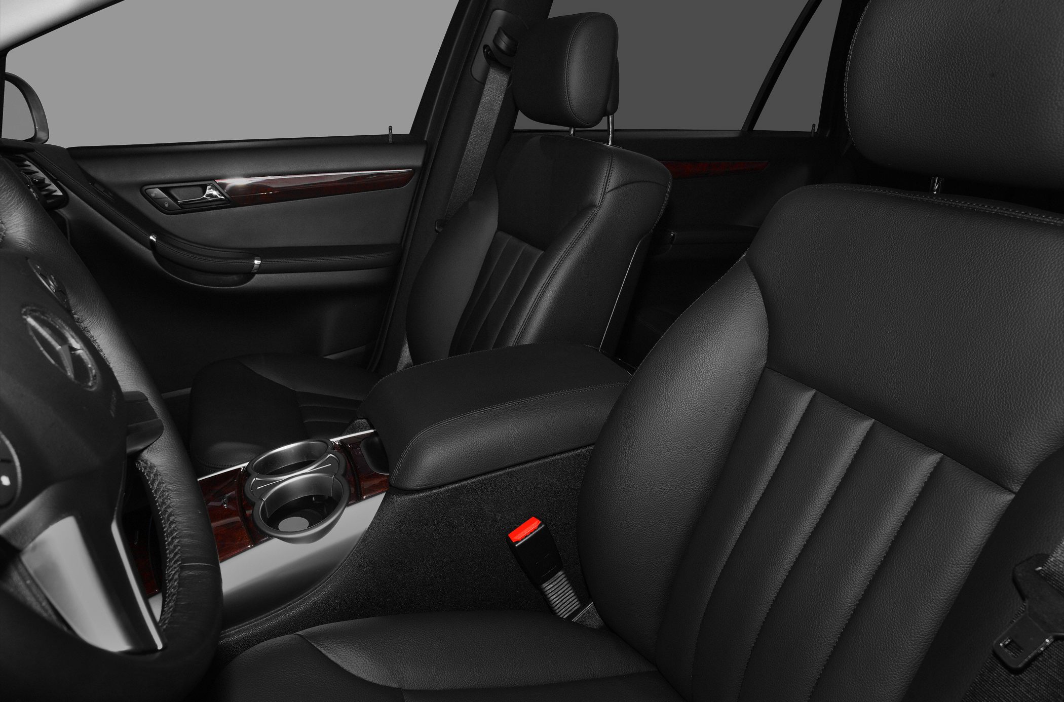 Black leather front seats with wood grain trim and center armrest