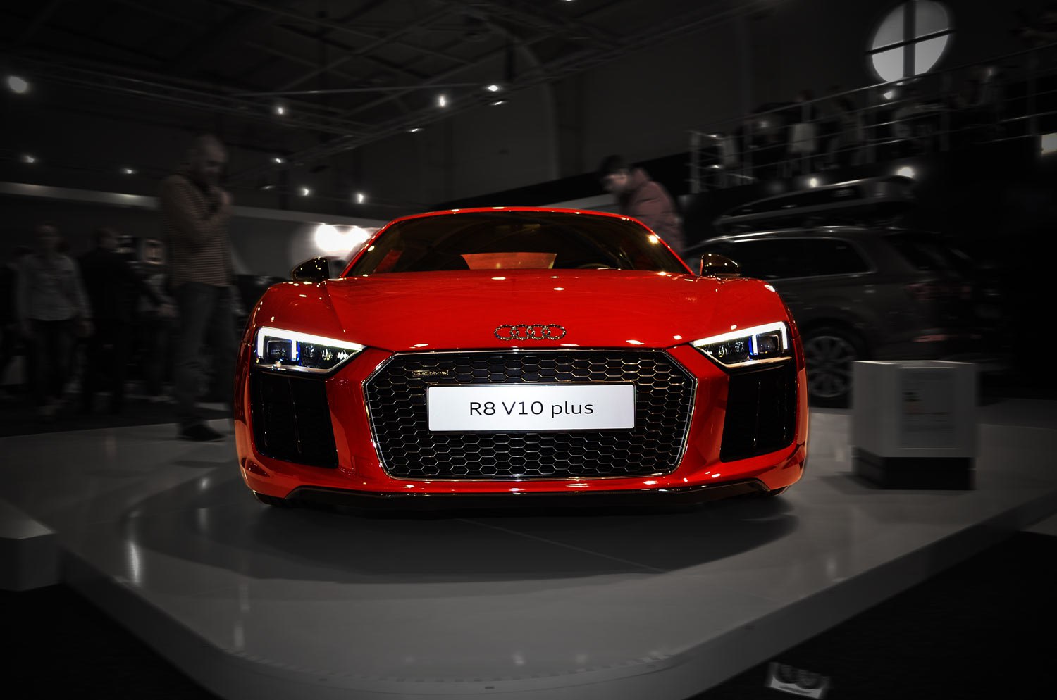 Front view of sporty car with LED headlights and hexagonal grille