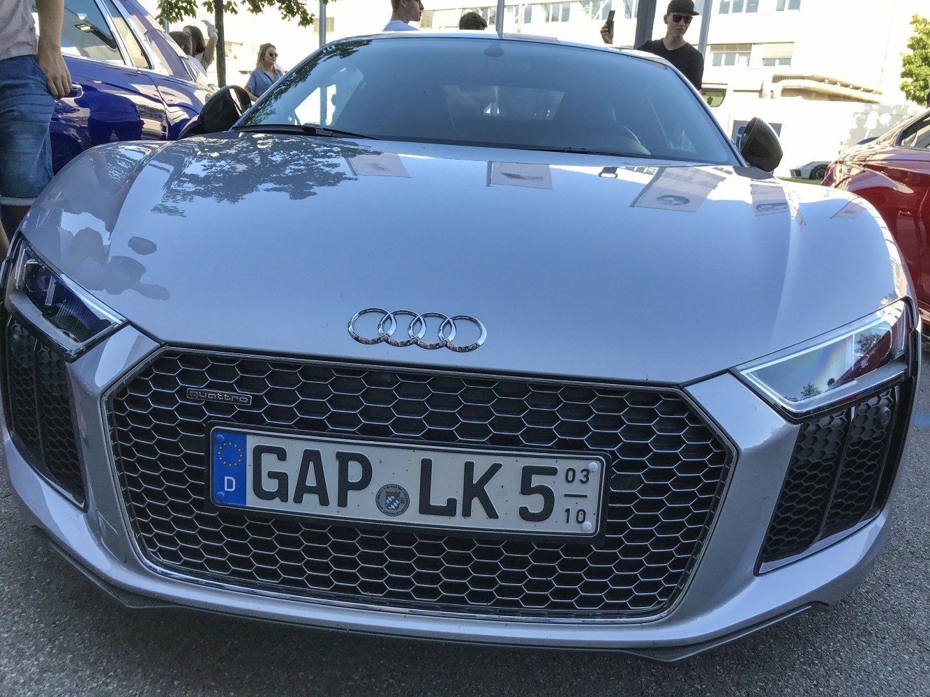 Close-up of front grille and angular headlights with honeycomb mesh pattern.