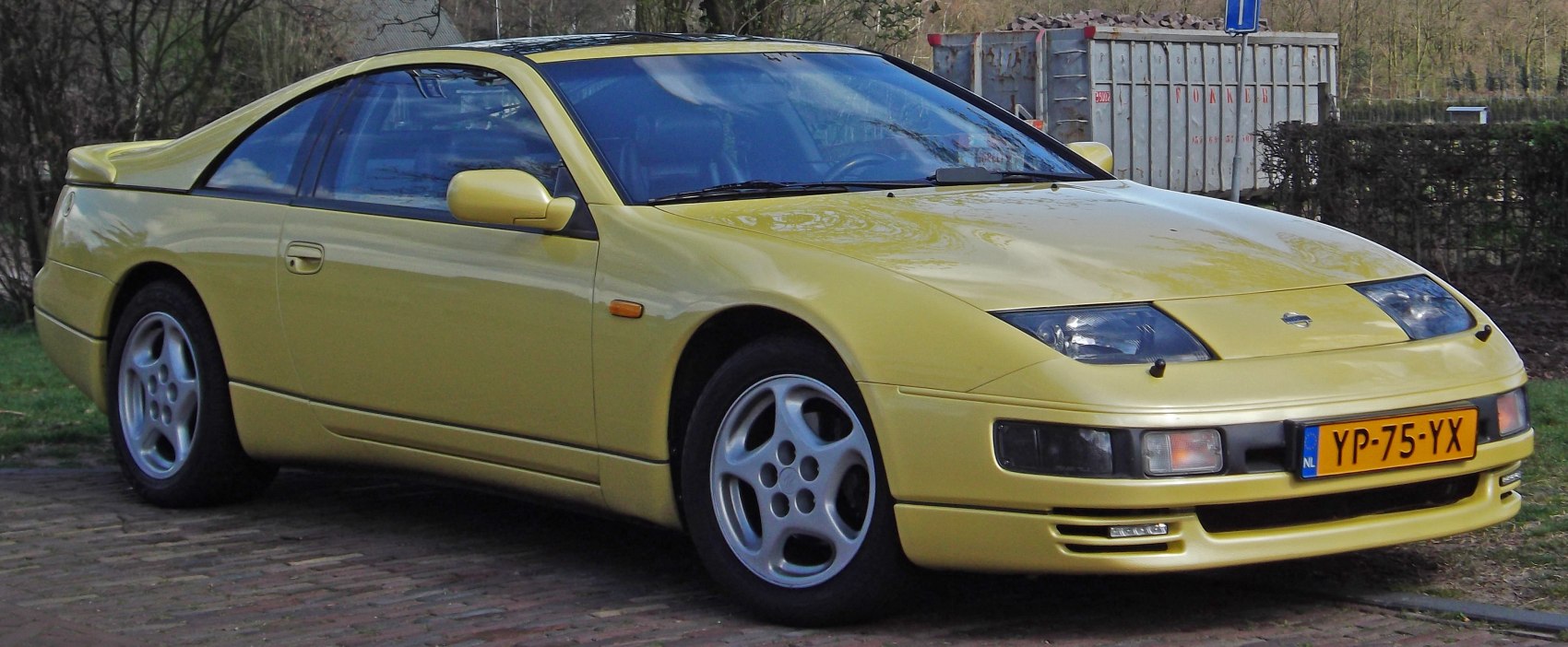 Yellow sports coupe with pop-up headlights and aerodynamic body