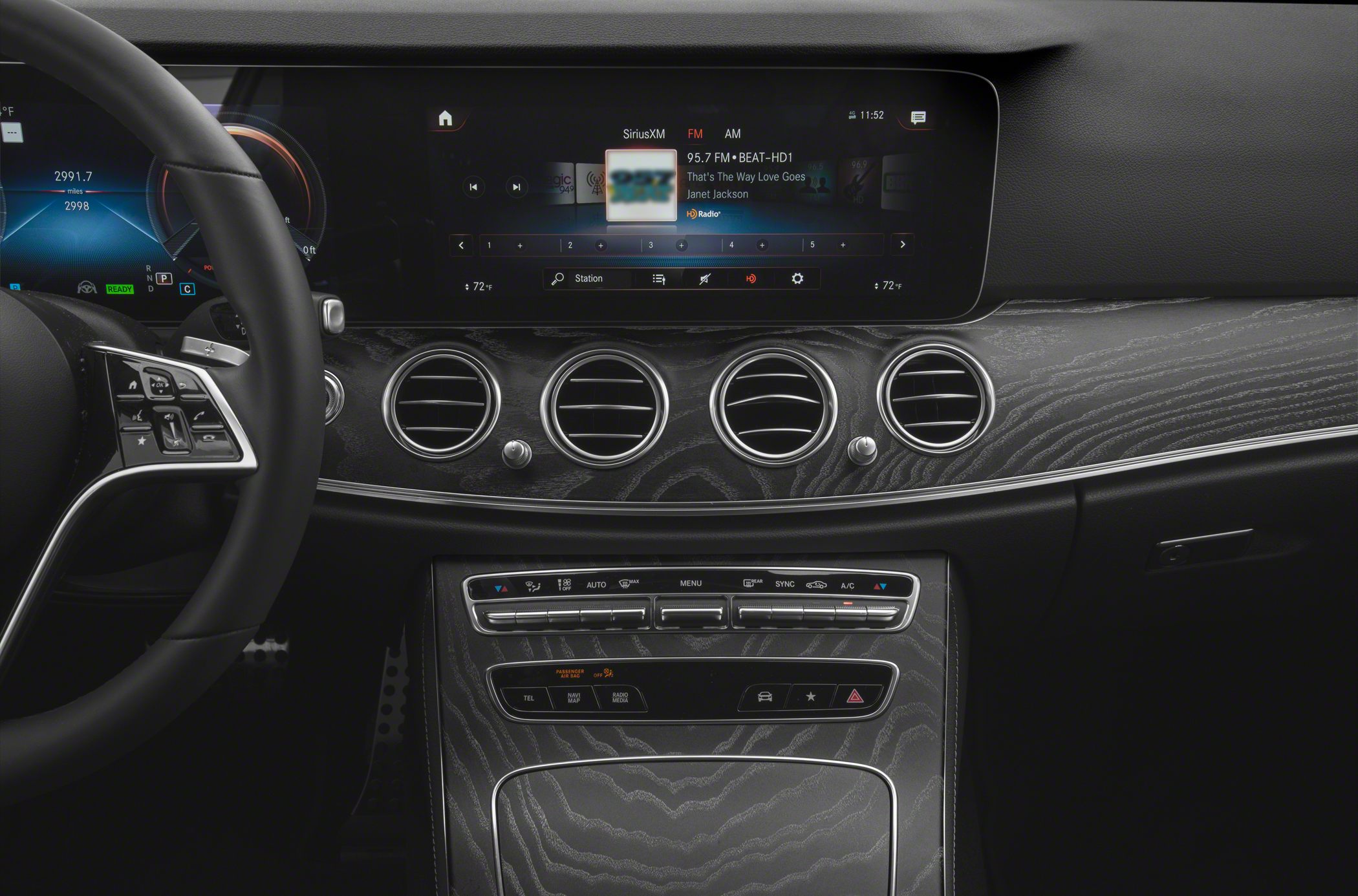 Wide digital display and wood grain dashboard trim with climate control panel