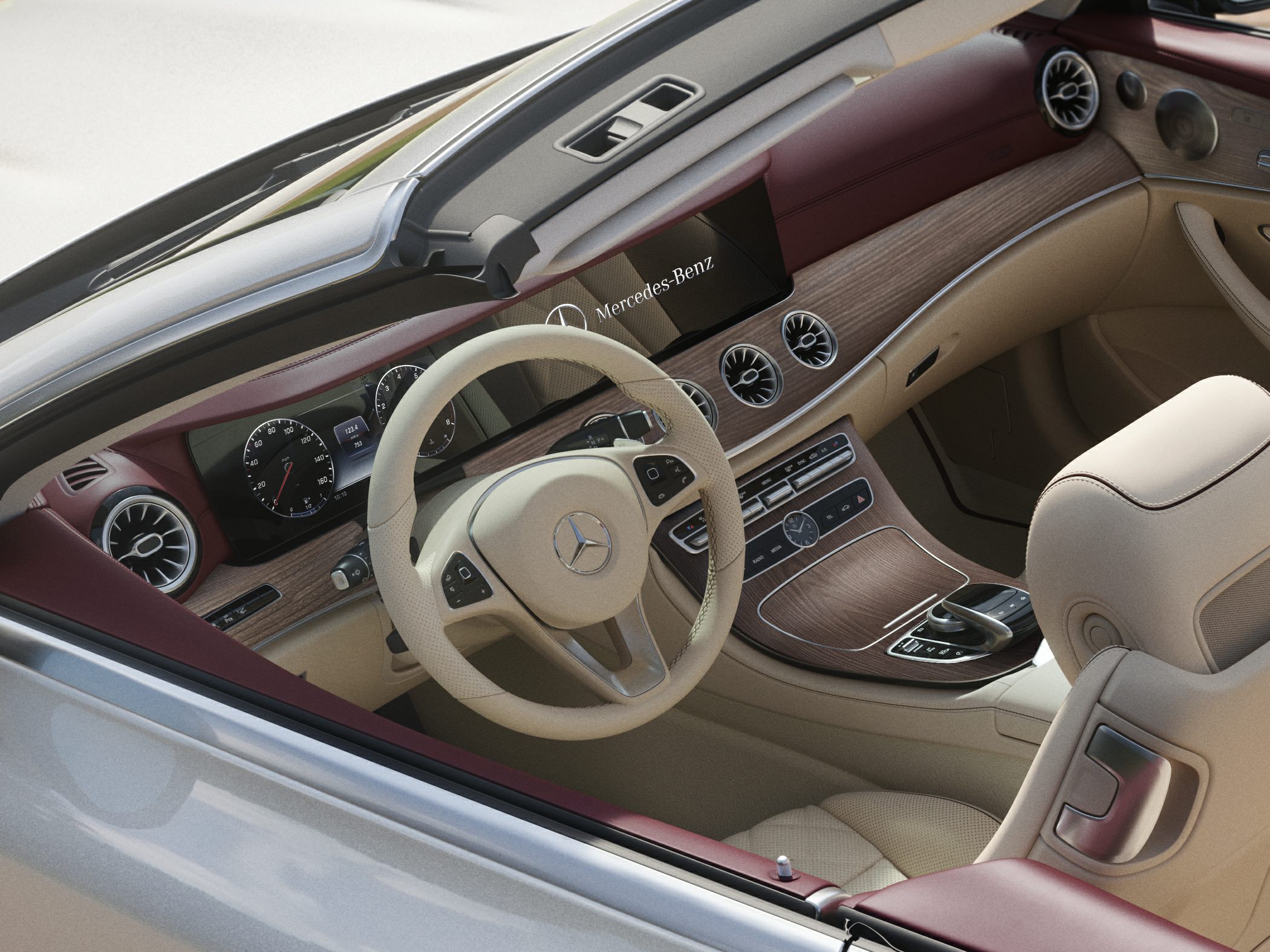 Beige steering wheel and wood-trimmed dashboard with digital displays
