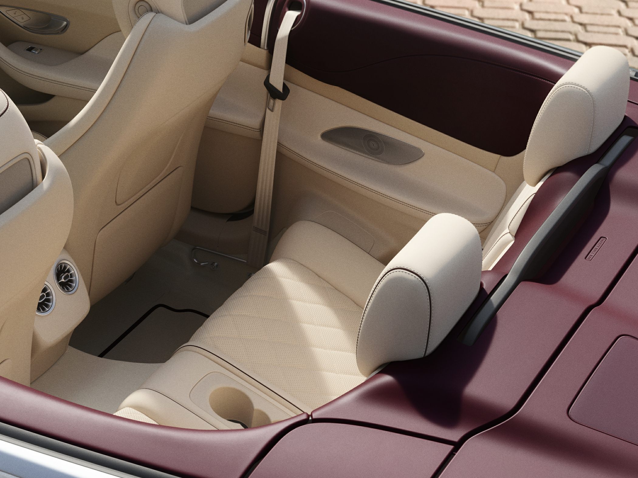 Beige leather rear seats with burgundy trim and air vents