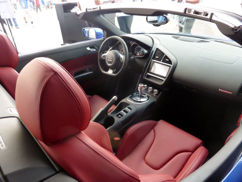 Red leather seats and modern dashboard of a convertible sports car interior