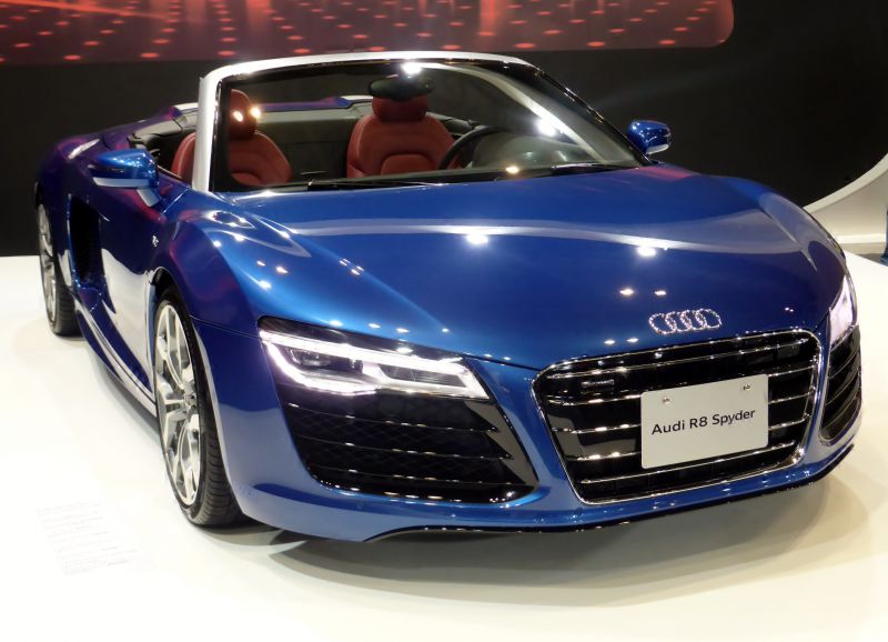 Blue convertible sports car with LED headlights and sleek front grille