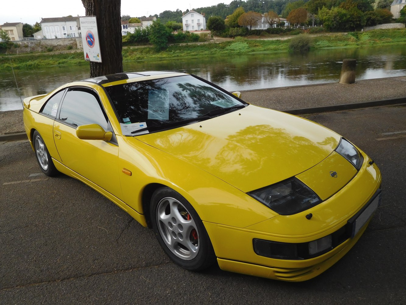 Yellow sports coupe with pop-up headlights and aerodynamic design