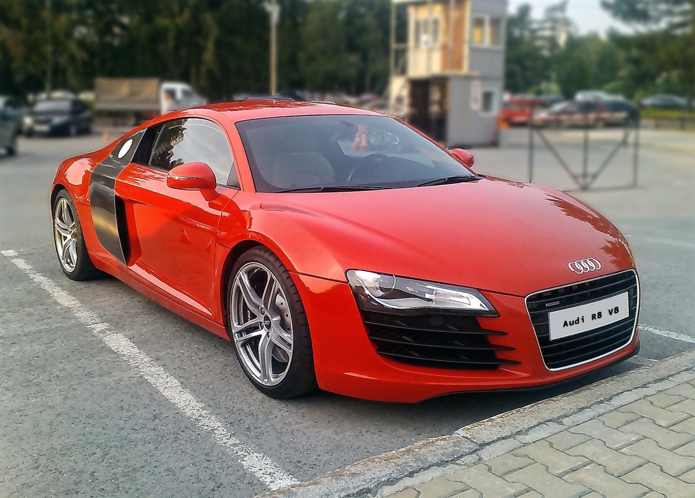 Red sports coupe with black side blade and sleek headlights