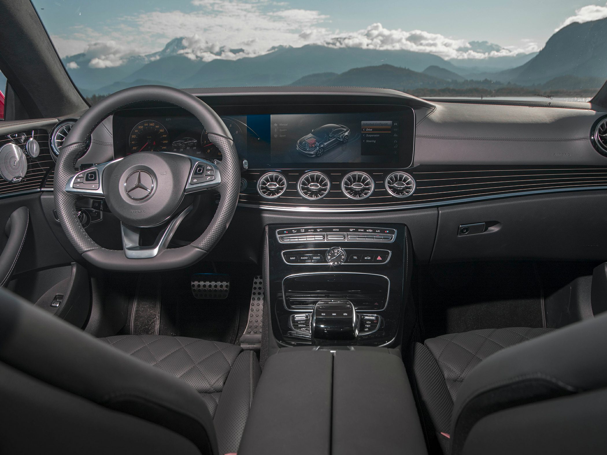 Luxury car interior with modern dashboard and multifunction steering wheel