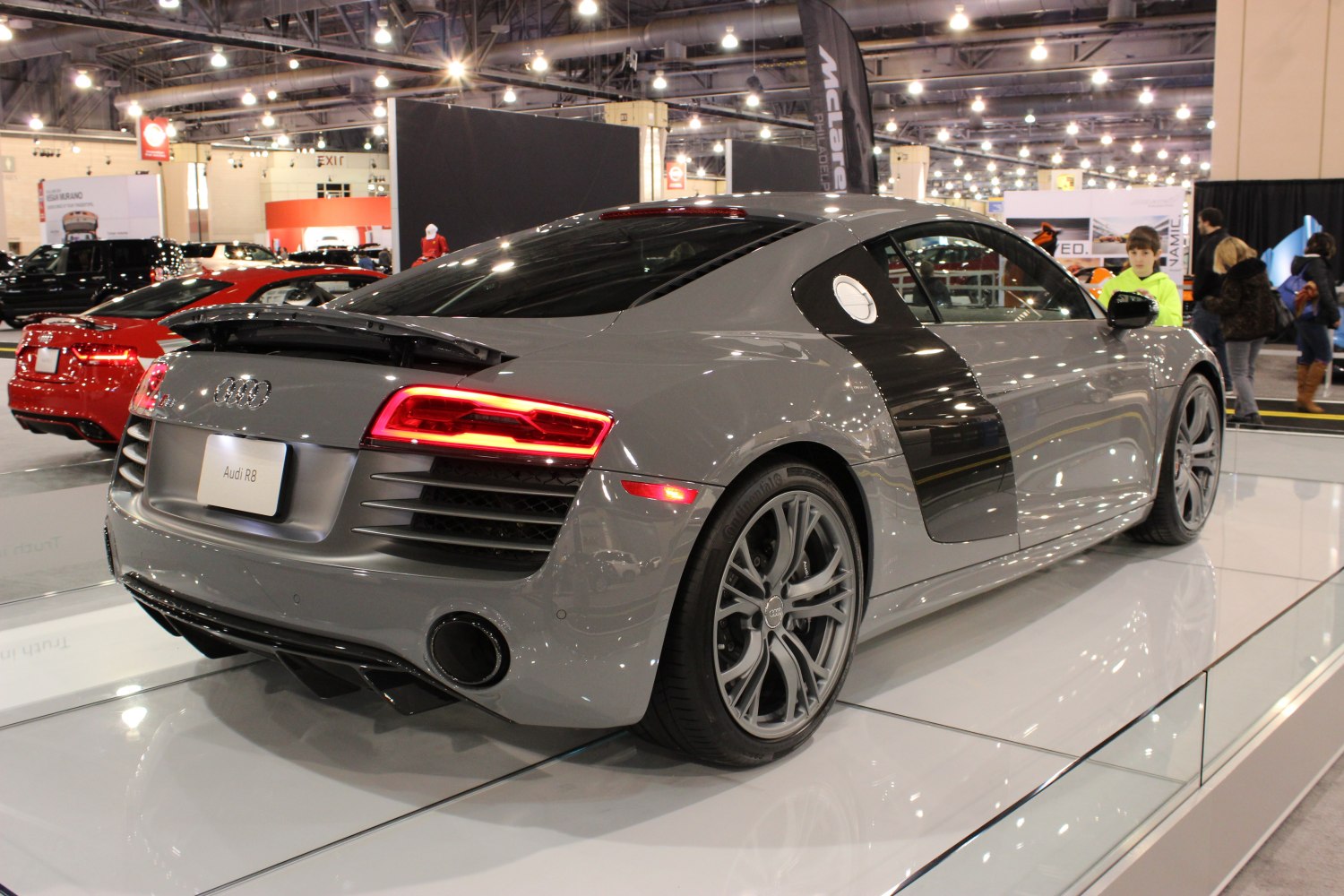 Grey sports coupe rear side with LED taillights and rear spoiler