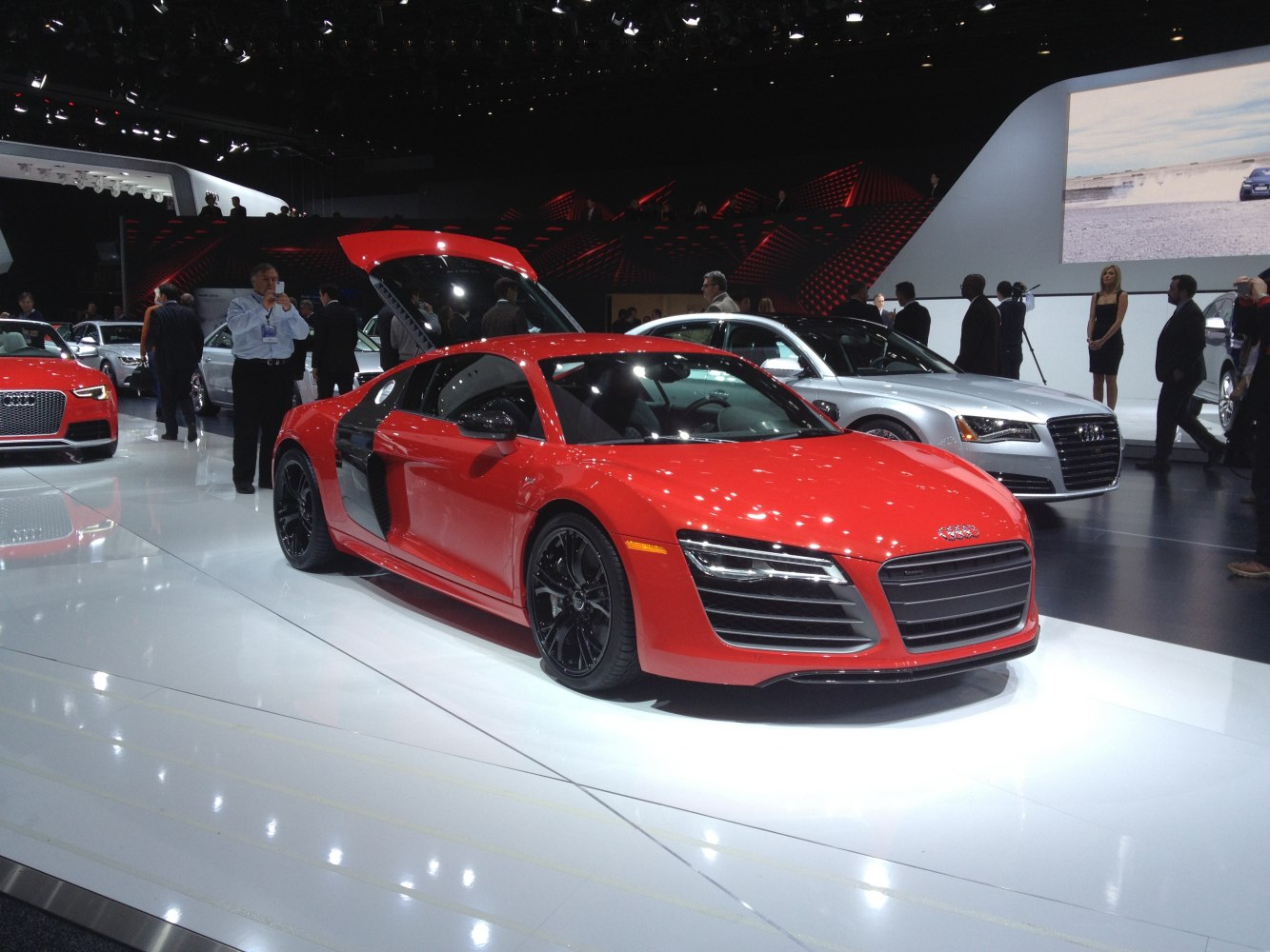 Red sports coupe with open rear hood and black alloy wheels