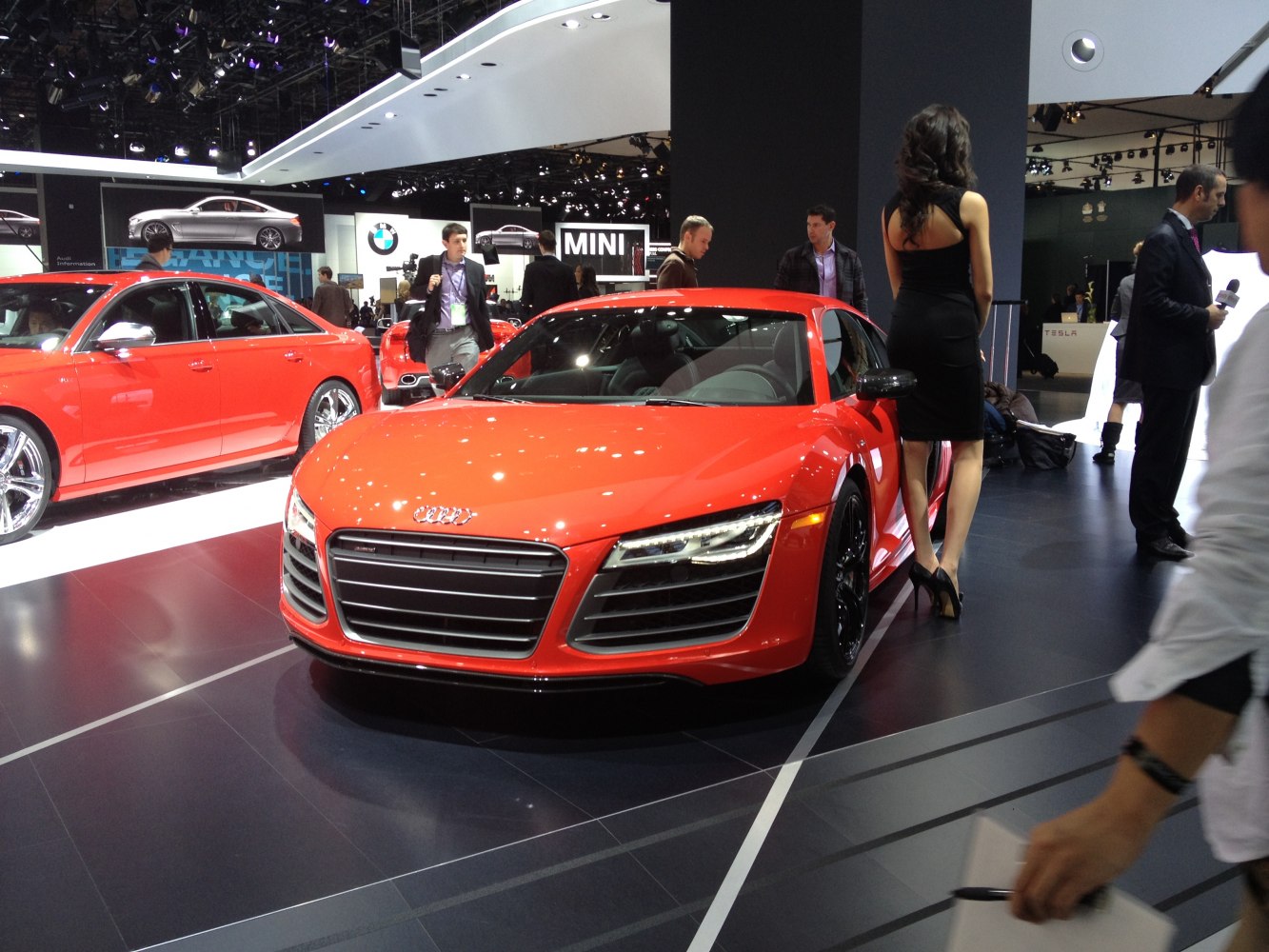 Red sports coupe front view with distinct grille and LED headlights