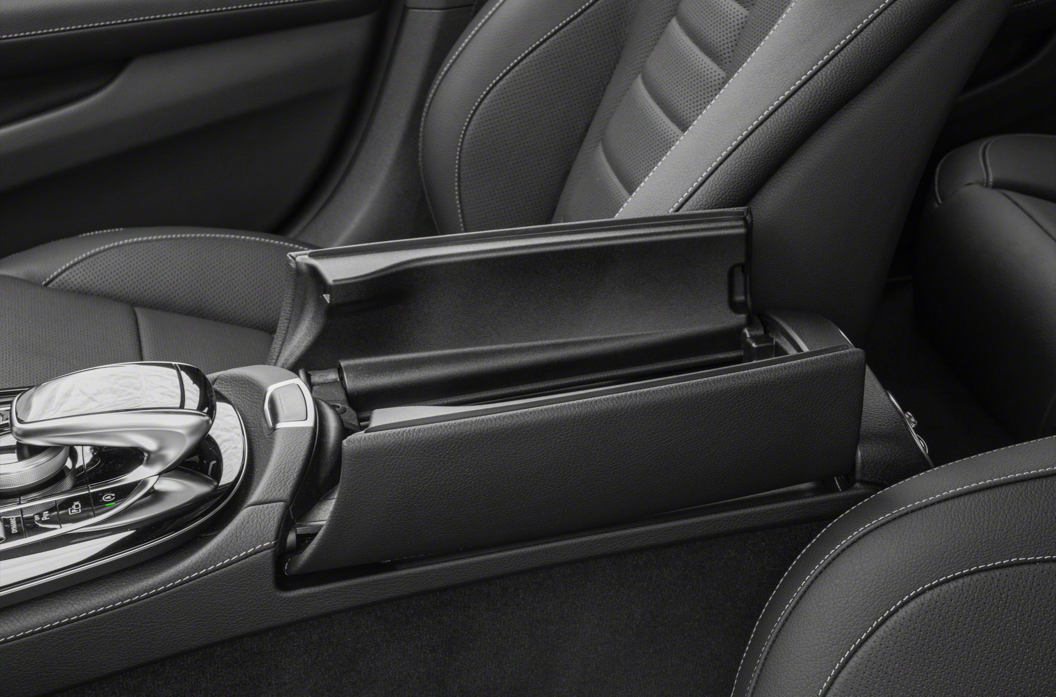 Center console storage and black leather seats with stitching