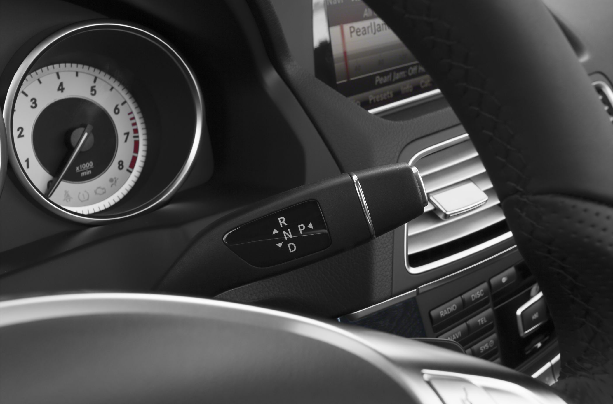 Gear shift lever and tachometer in car interior