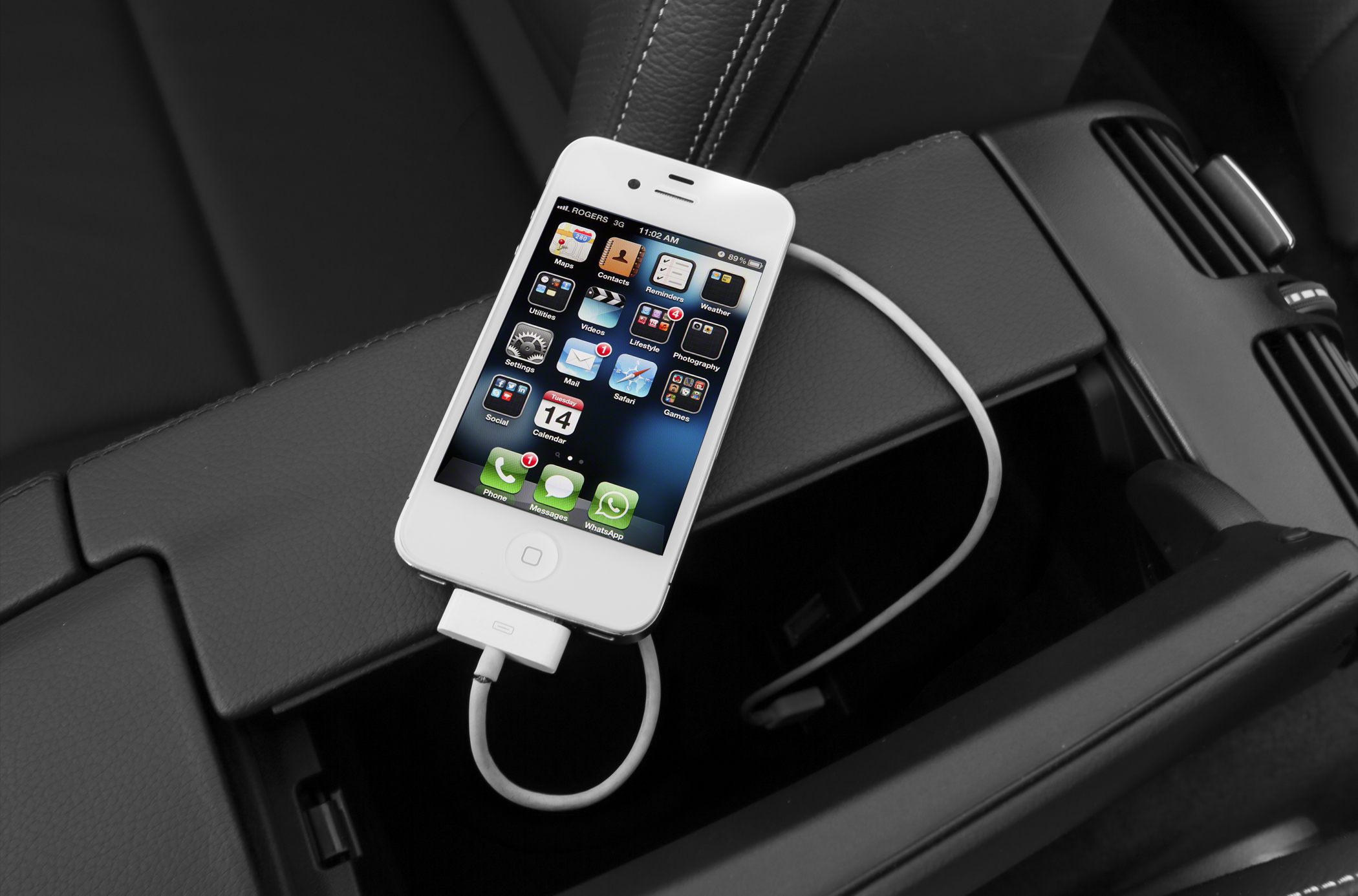 Smartphone charging setup in luxury car interior
