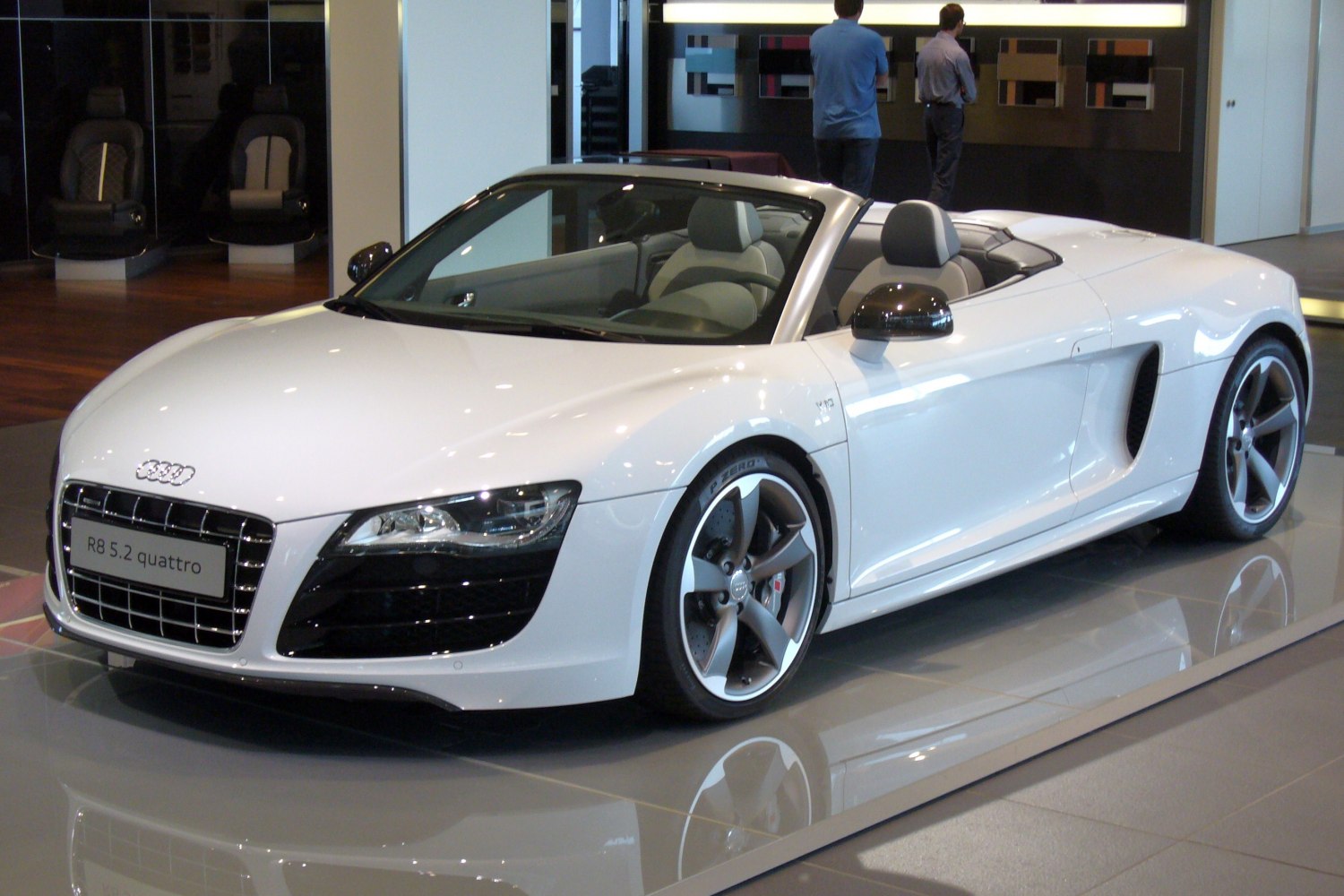 White convertible sports car with open roof and sleek design
