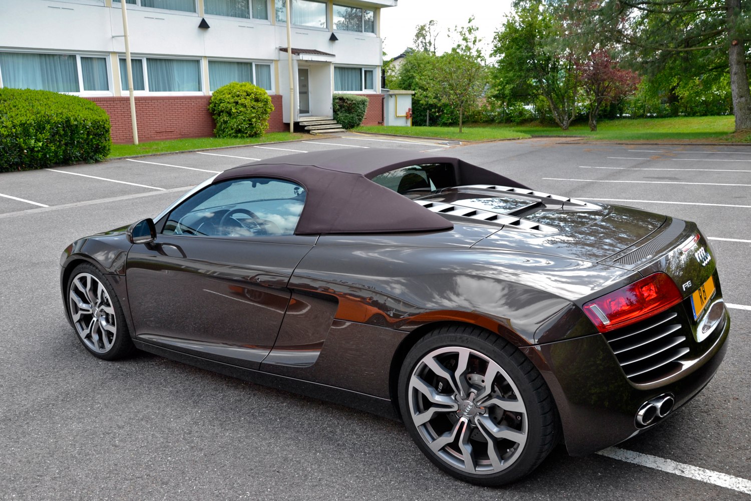Convertible sports car soft-top roof and rear vent detailed side rear view