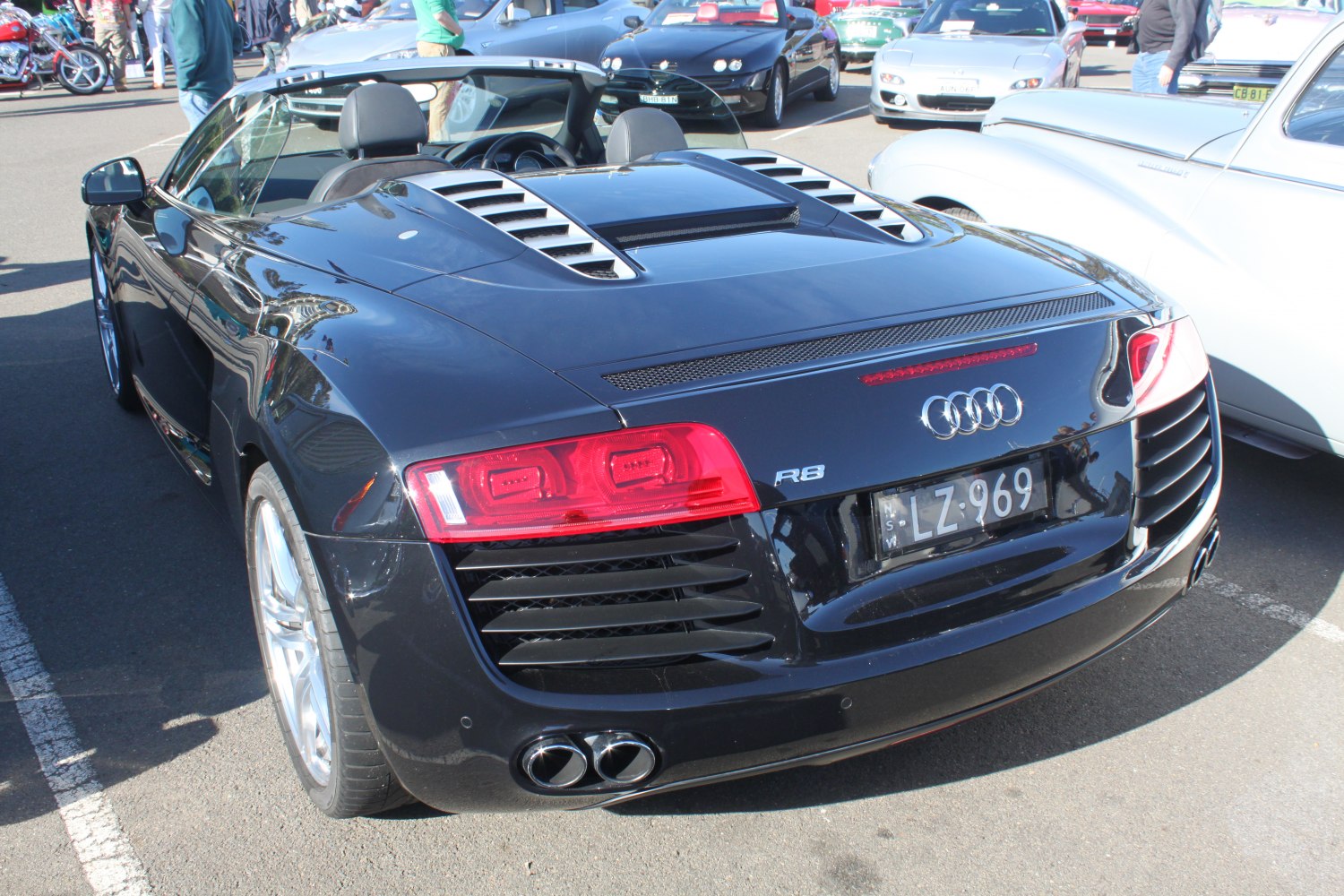Rear view with sporty dual exhausts, taillights, and vents
