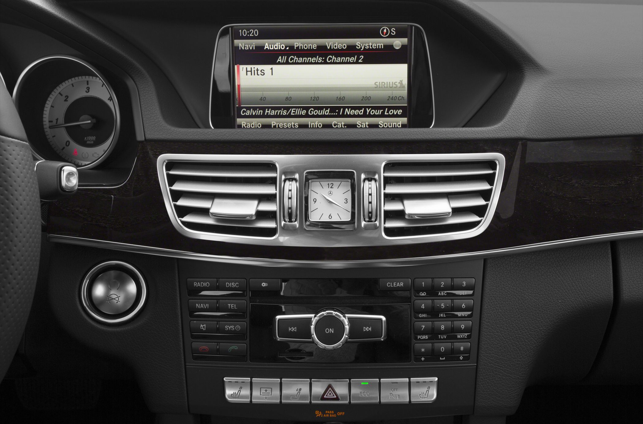 Luxury car dashboard with analog clock and infotainment display